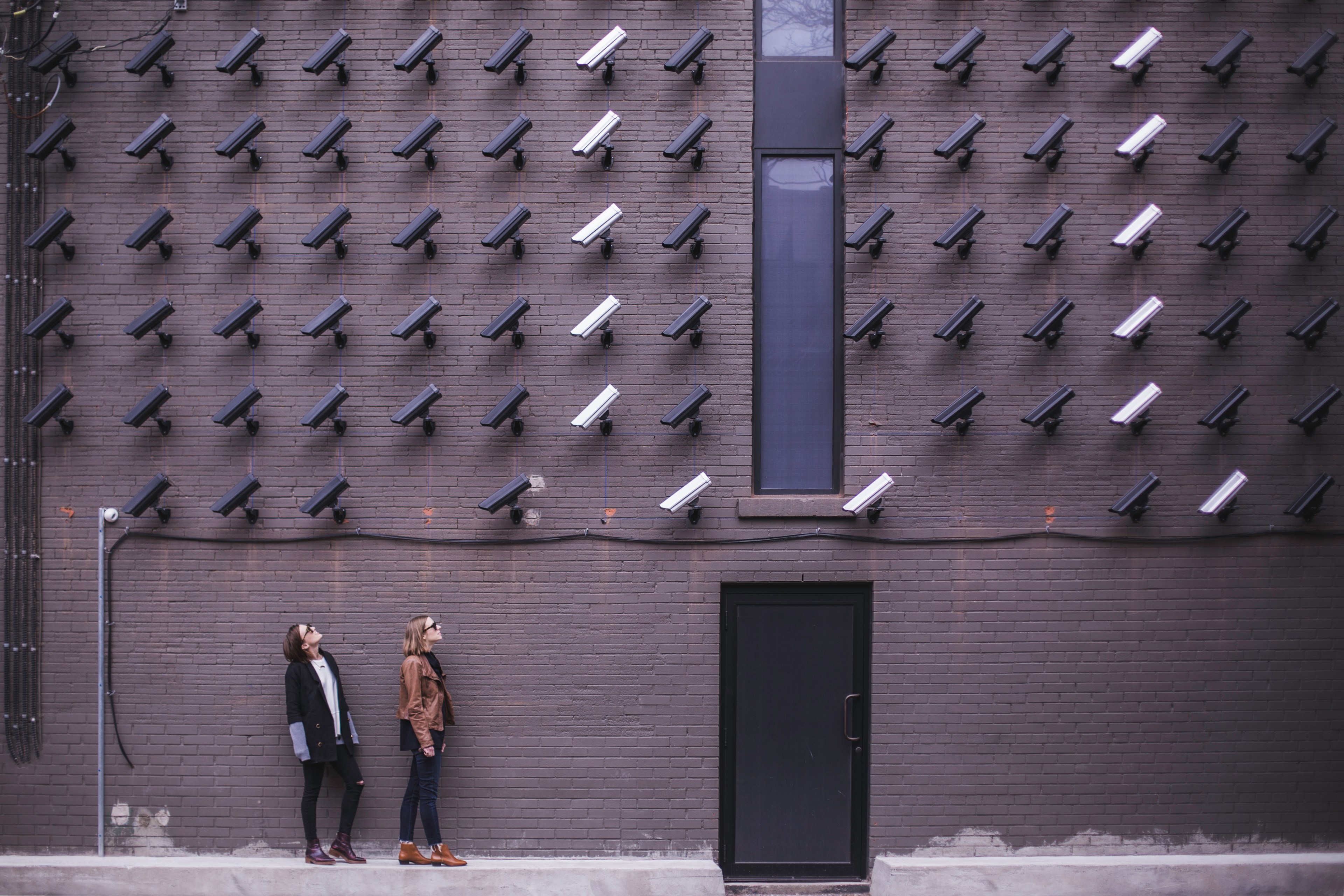 women viewing modern art with black and white surveillance cameras on wall in toronto, women look at security cameras 4k, HD Wallpaper
