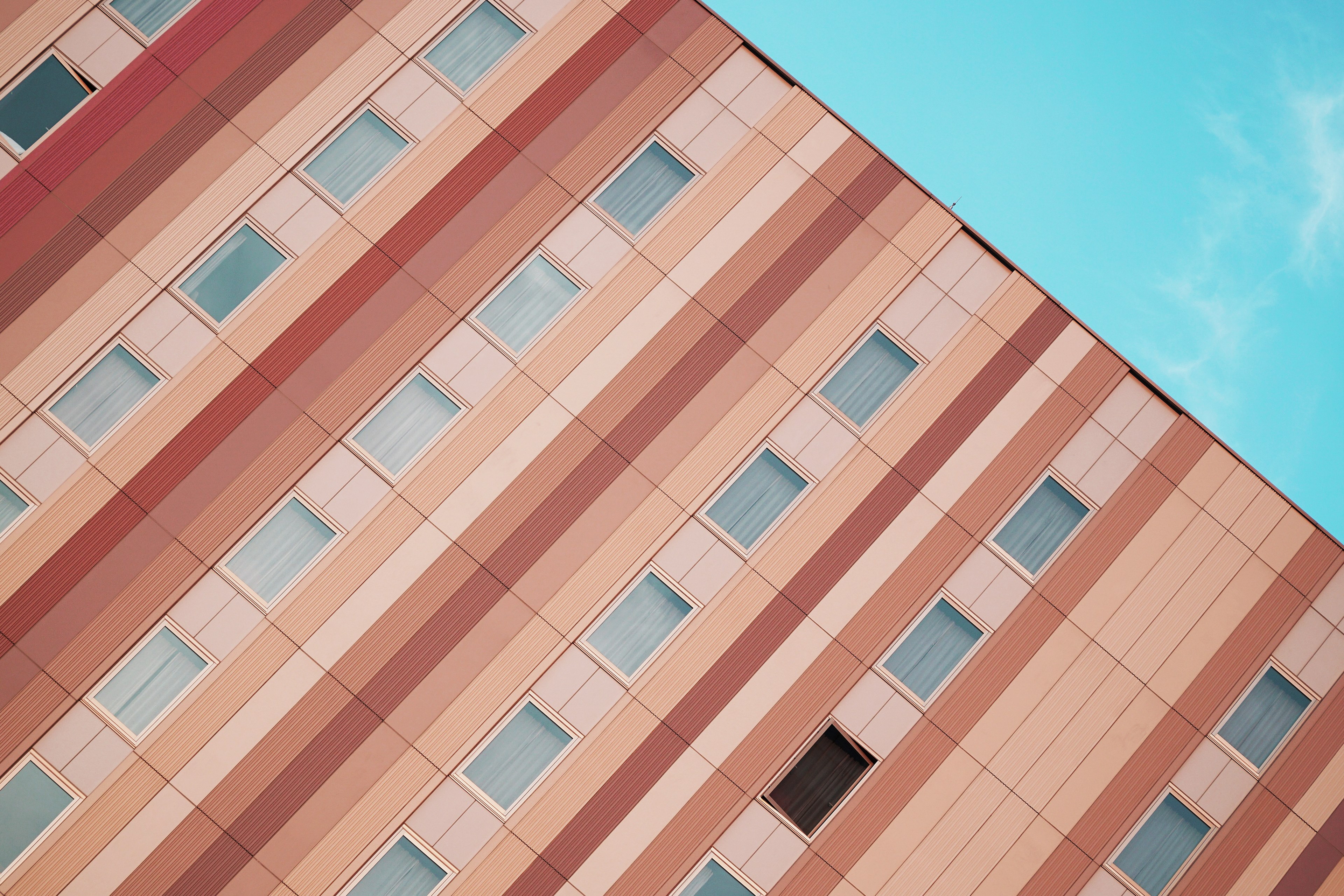 an angular shot of a residential building facade painted with pastel colored stripes, pastel stripes on a facade 4k, HD Wallpaper