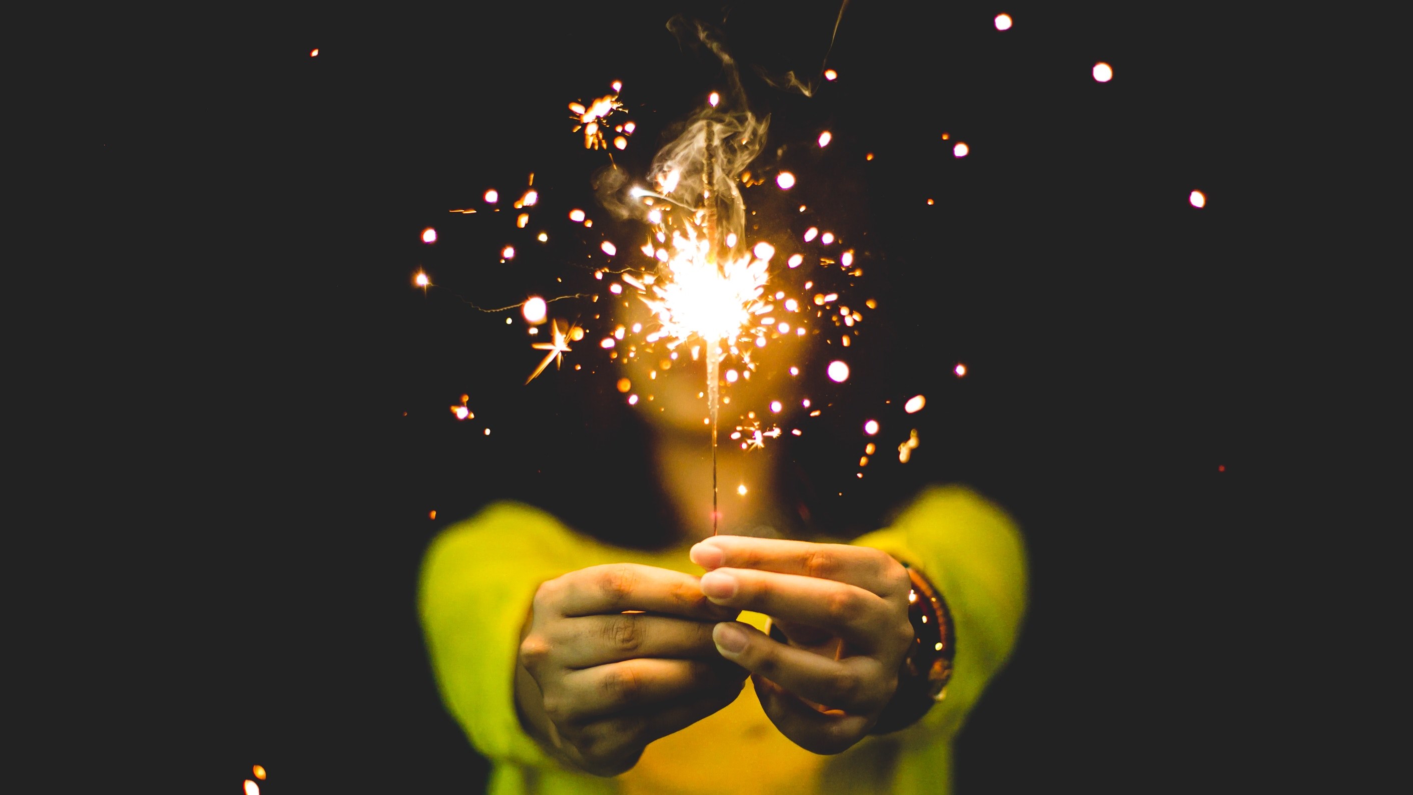 a person holding a lit sparkler in front of them, bright sparkler at night 4k, HD Wallpaper