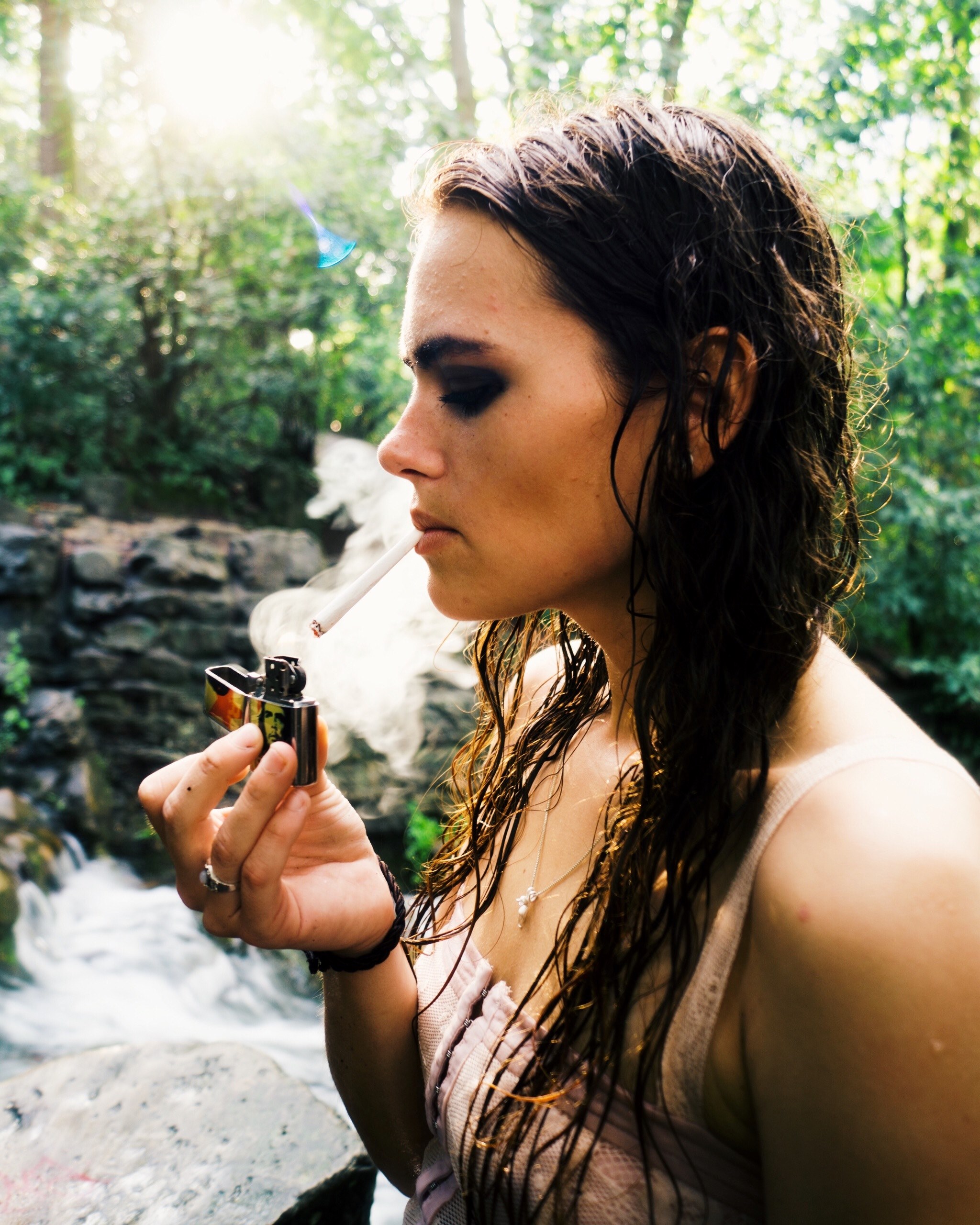 woman with wet hair lights a cigarette in the forest, smoke 4k, Phone HD Wallpaper