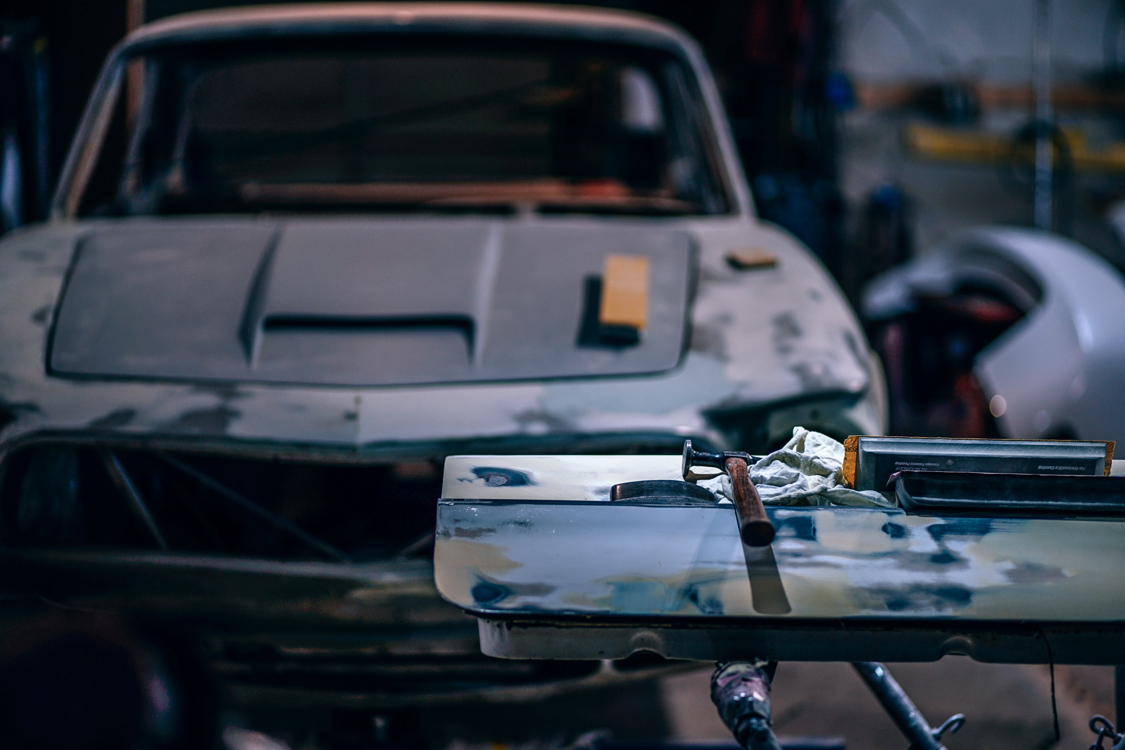 the front view of an old ford mustang being fixed up with mechanics tools on the foreground, _car shop 4k, HD Wallpaper