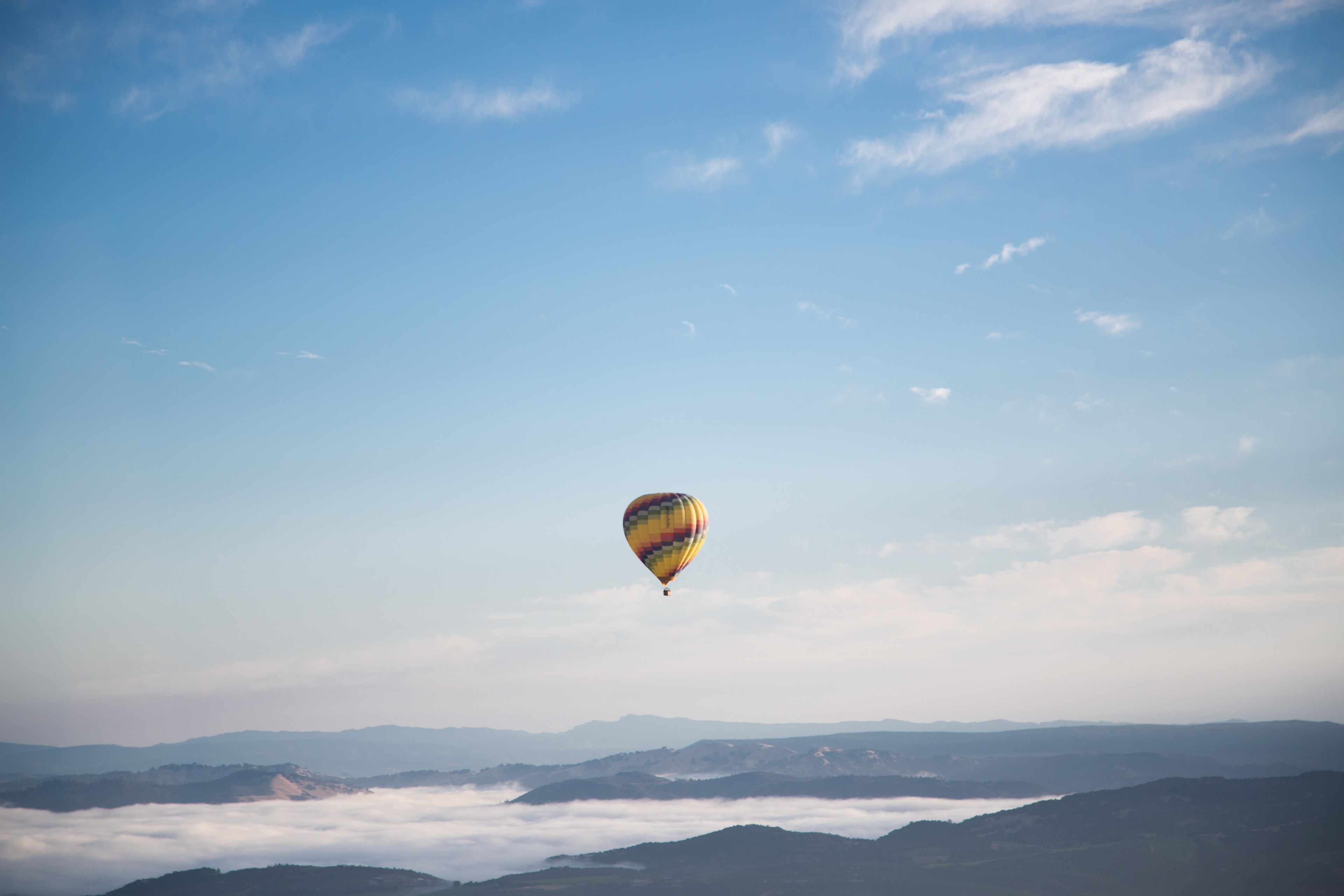 hot air balloon flying over a foggy mountain landscape, hot air balloon in the sky 4k, HD Wallpaper