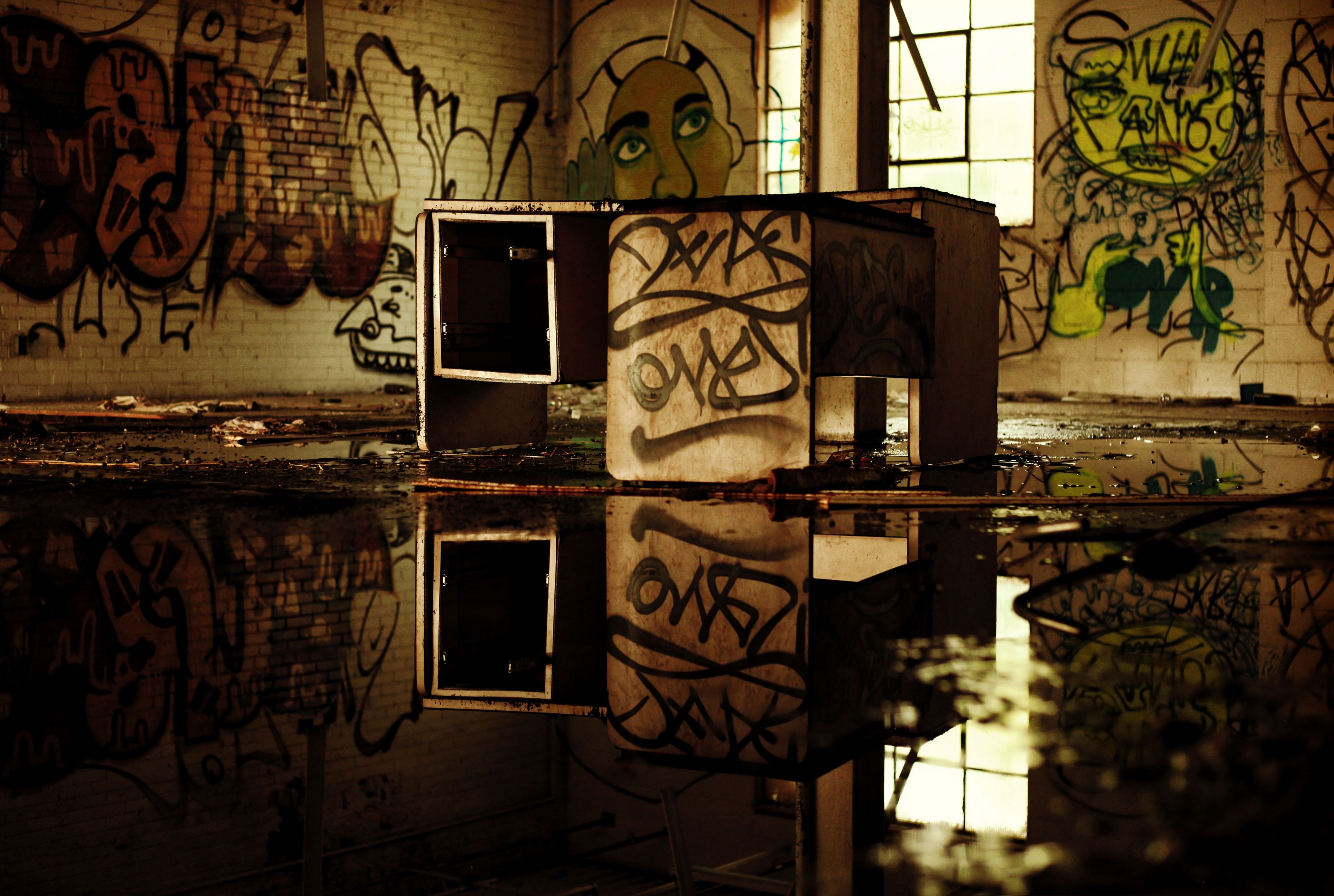 a dilapidated desk on a wet floor in an abandoned building with graffiti on its walls, urban exploring 4k, HD Wallpaper