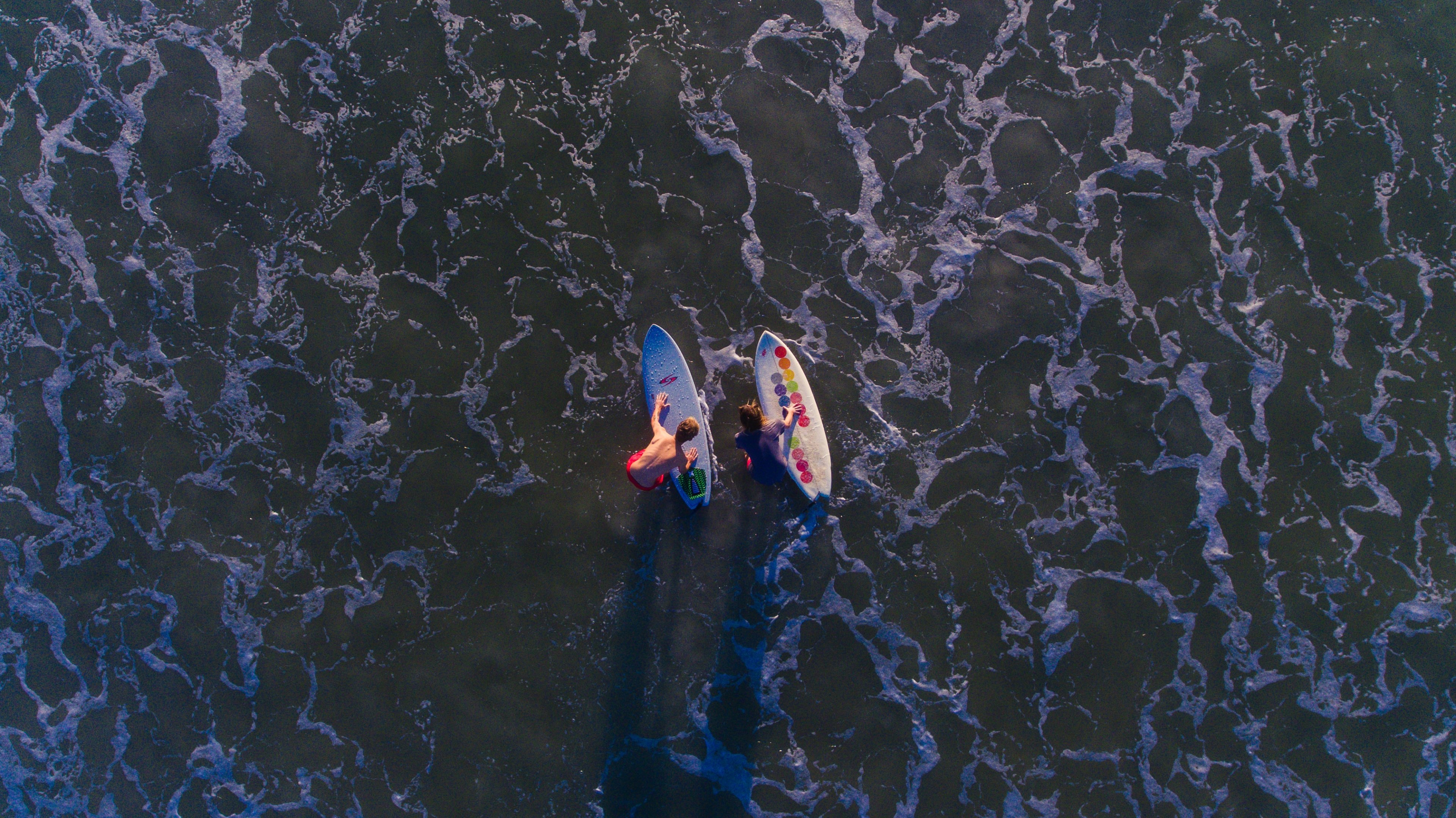 a drone shot aerial view of two surfers on their boards at northside jacksonville florida united states, seth amp sean 4k, HD Wallpaper