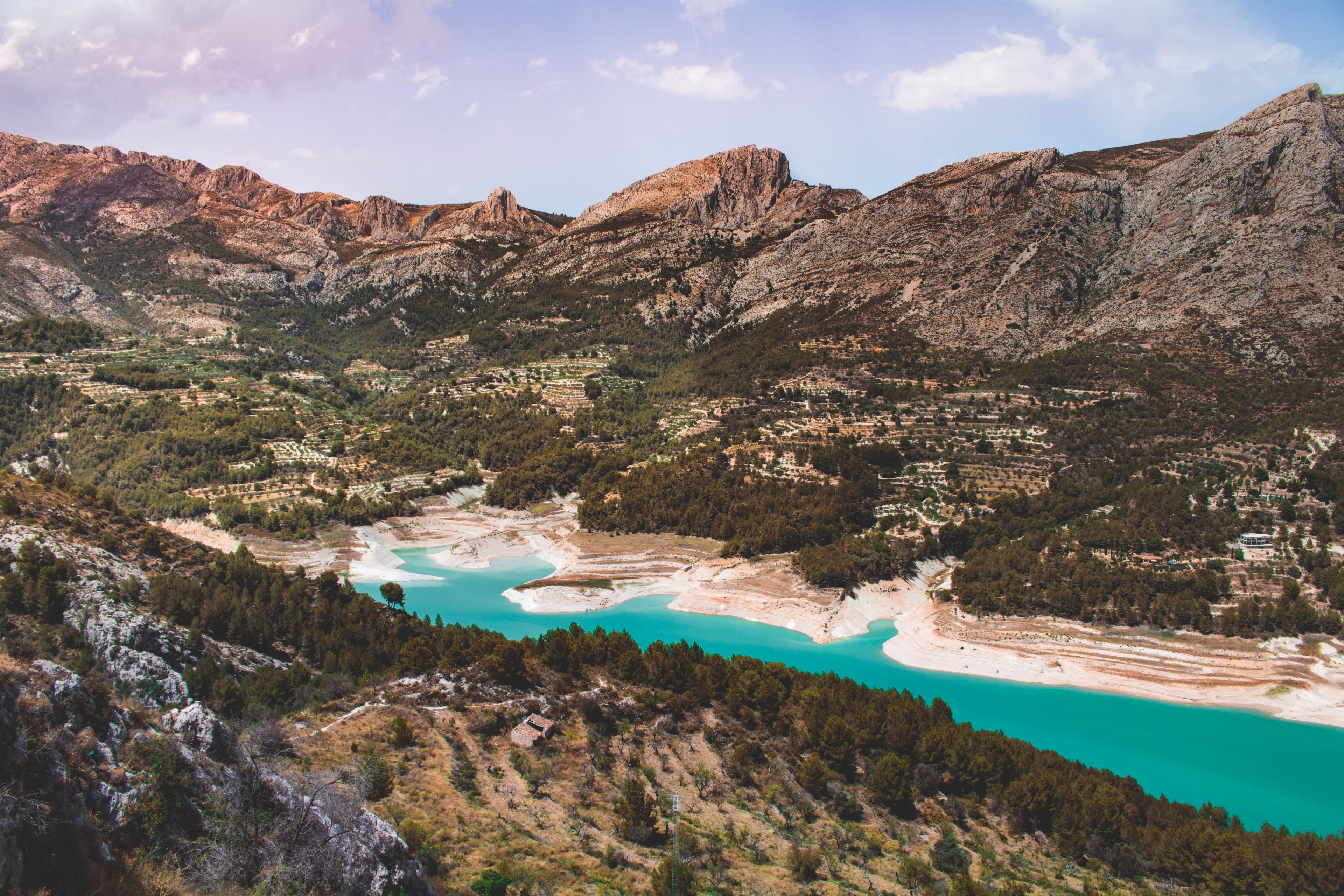 a blue lake surrounded by low mountains on a sunny day in guadalest, mountain lake in the summer 4k, HD Wallpaper