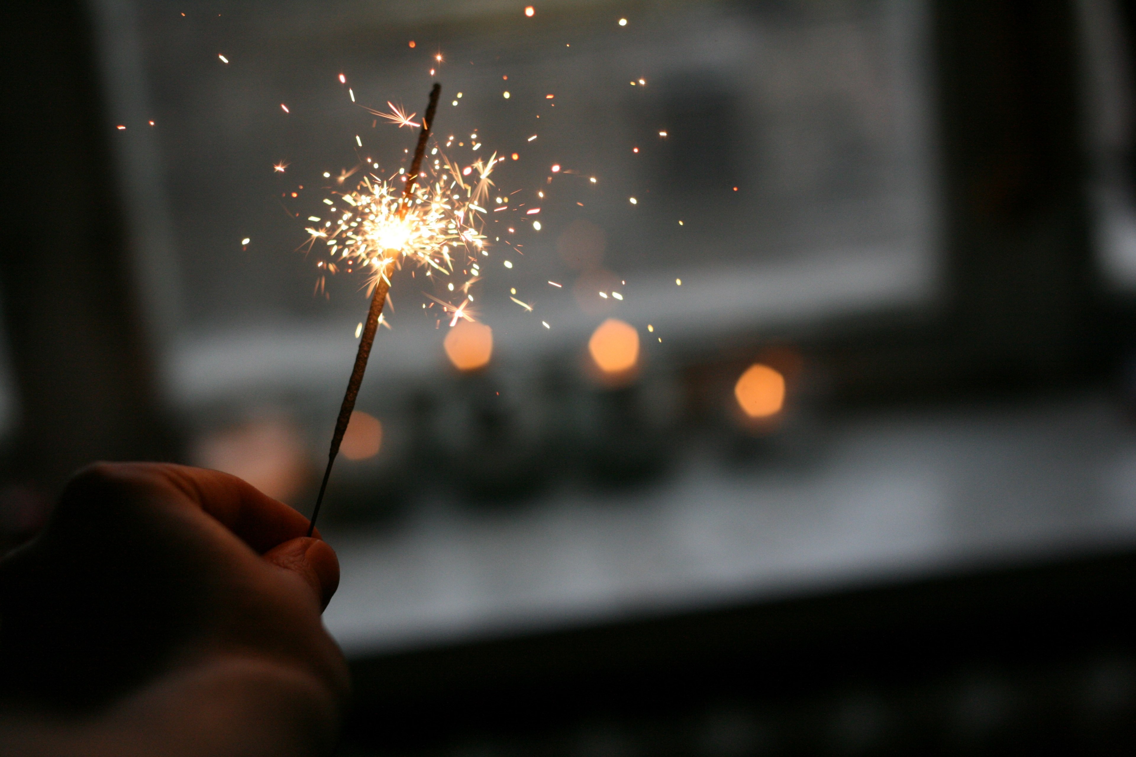 a person holding a sparkler near a window, christmas lights 4k, HD Wallpaper
