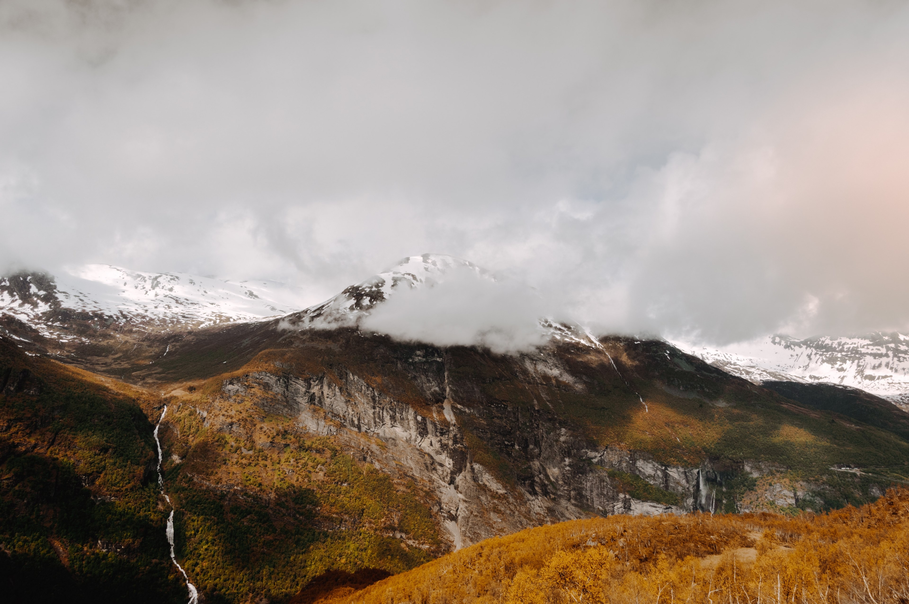majestic view of a mountain with a stream flowing down its side and clouds enveloping its peak, norway geiranger fjord 4k, HD Wallpaper