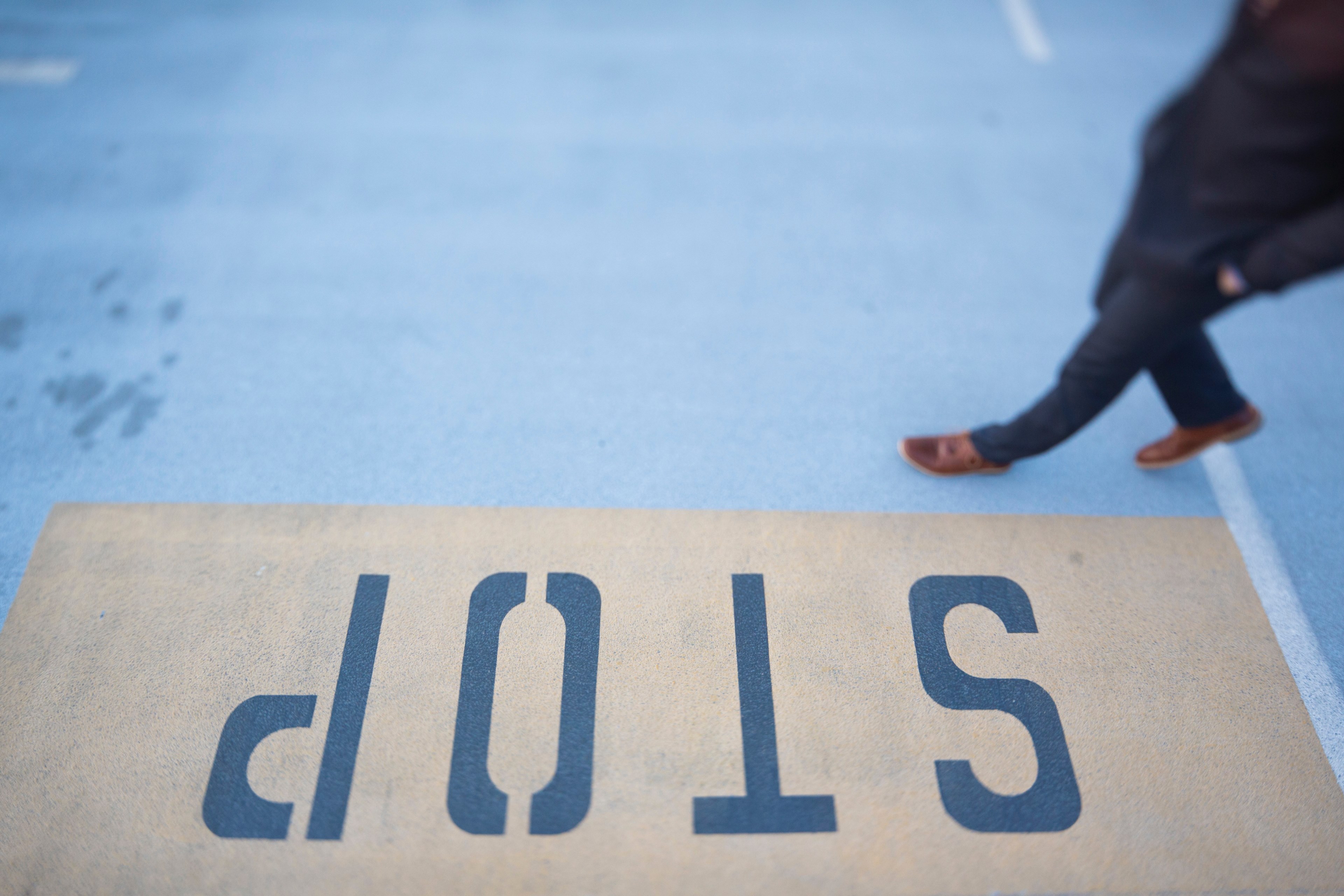 a person crossing a road near a painted stop sign, stop sign on asphalt 4k, HD Wallpaper