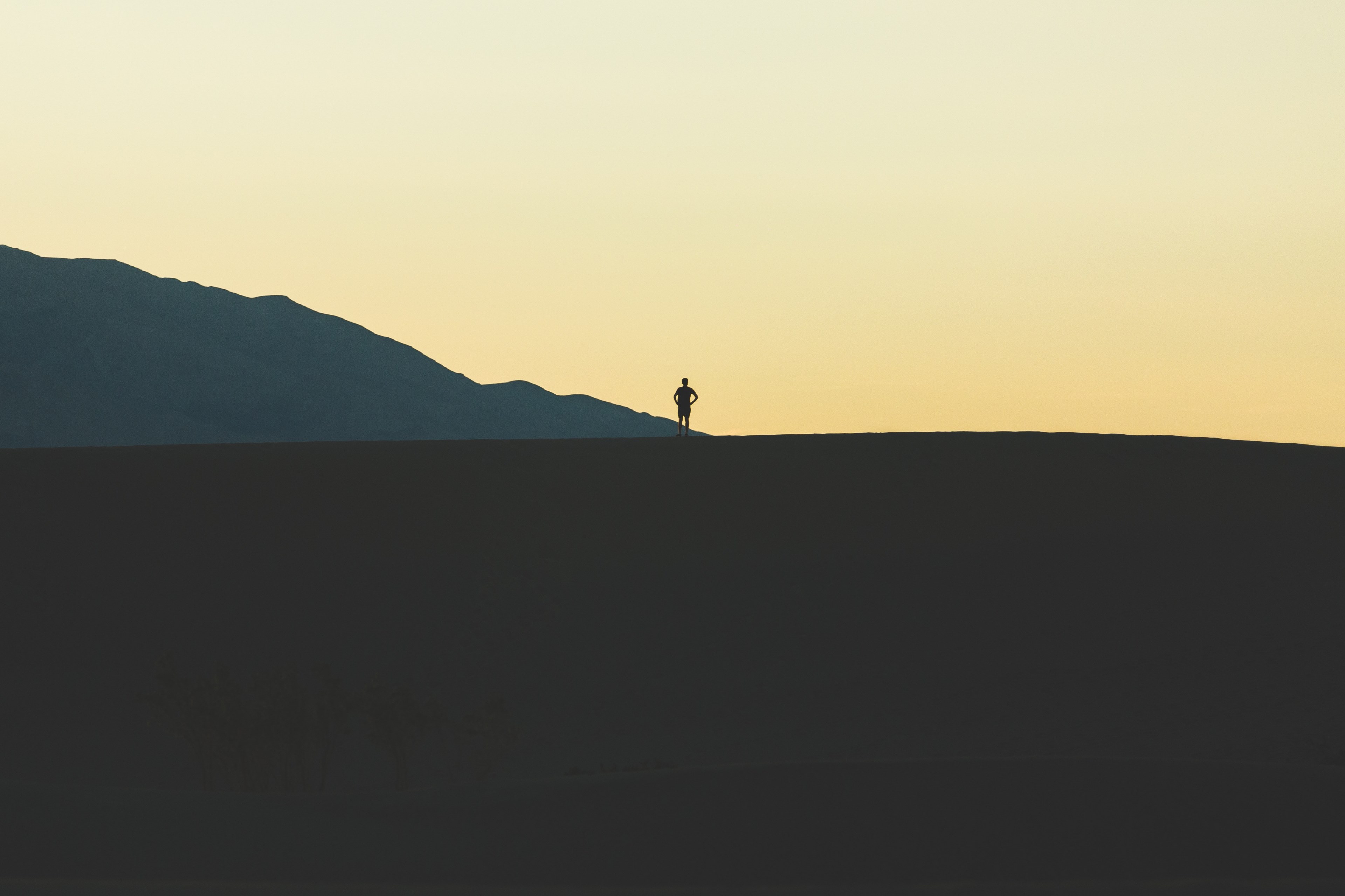 a persons silhoutte against the orange sky on a sand dune at death valley national park, hiking in death valley 4k, HD Wallpaper