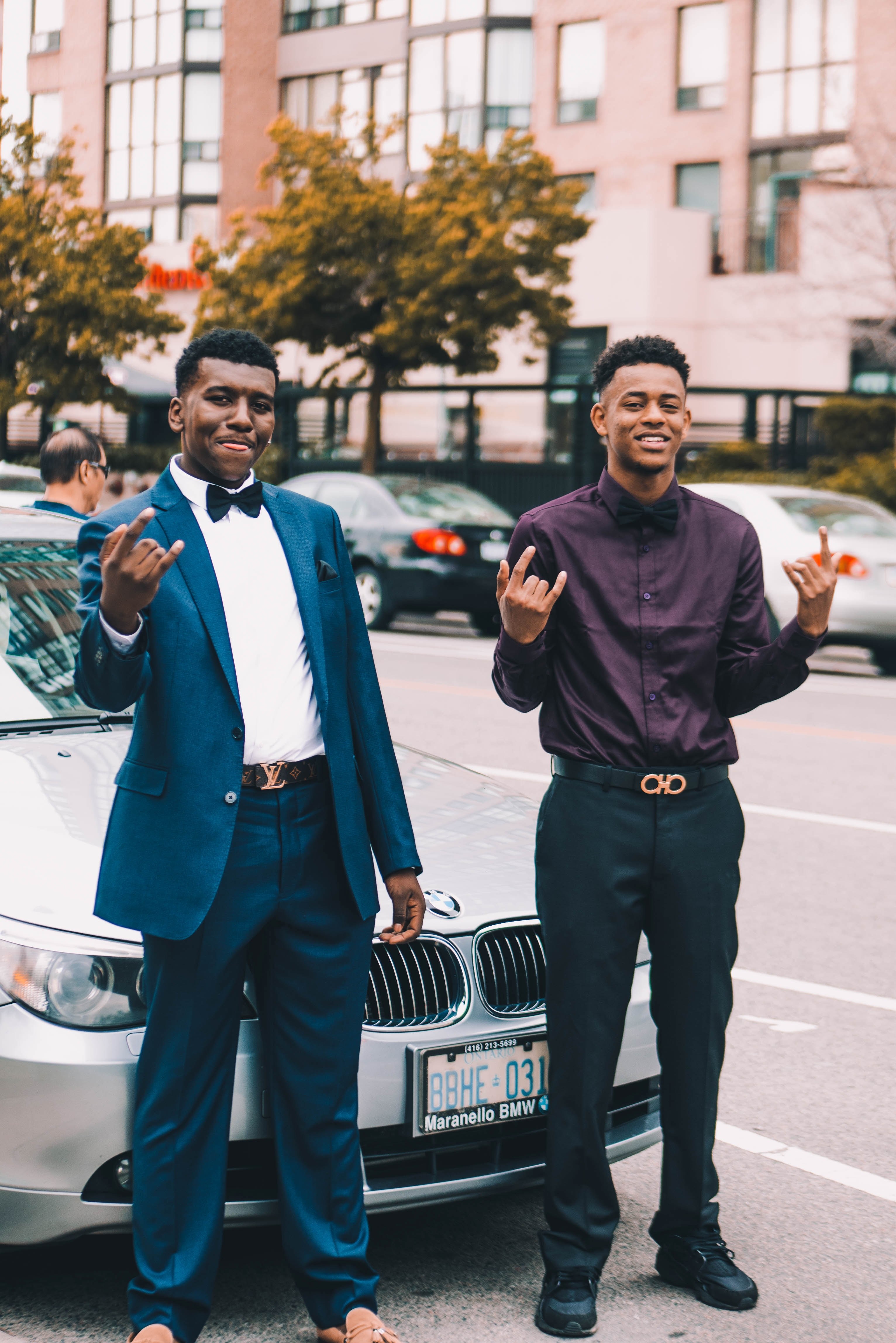 happy young men smile and pose in fancy suits by a bmw car, two men with bmw 4k, Phone HD Wallpaper