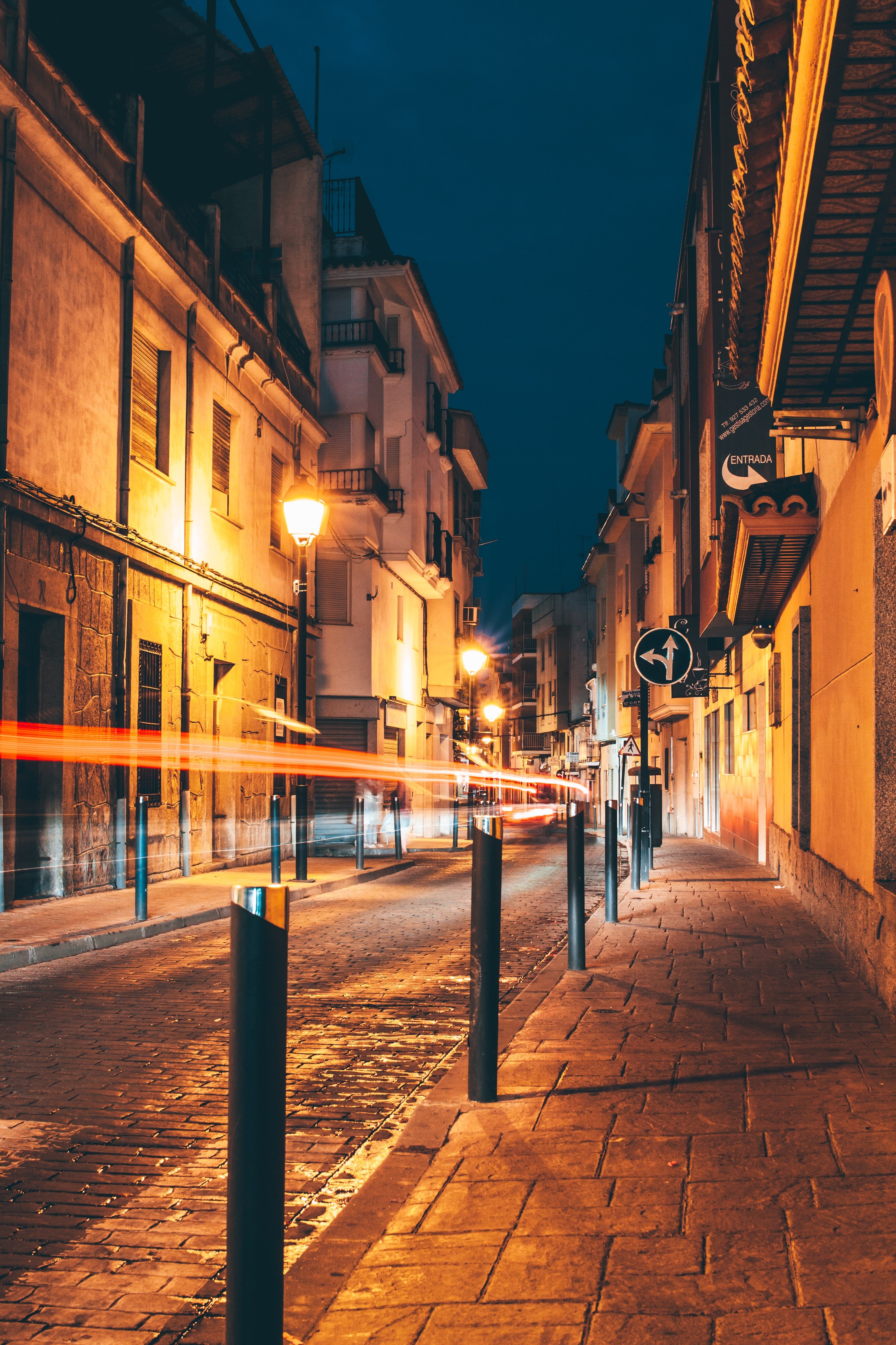 an early night shot of a street and the sidewalk in a historic part of town, historic architecture and light trails 4k, Phone HD Wallpaper