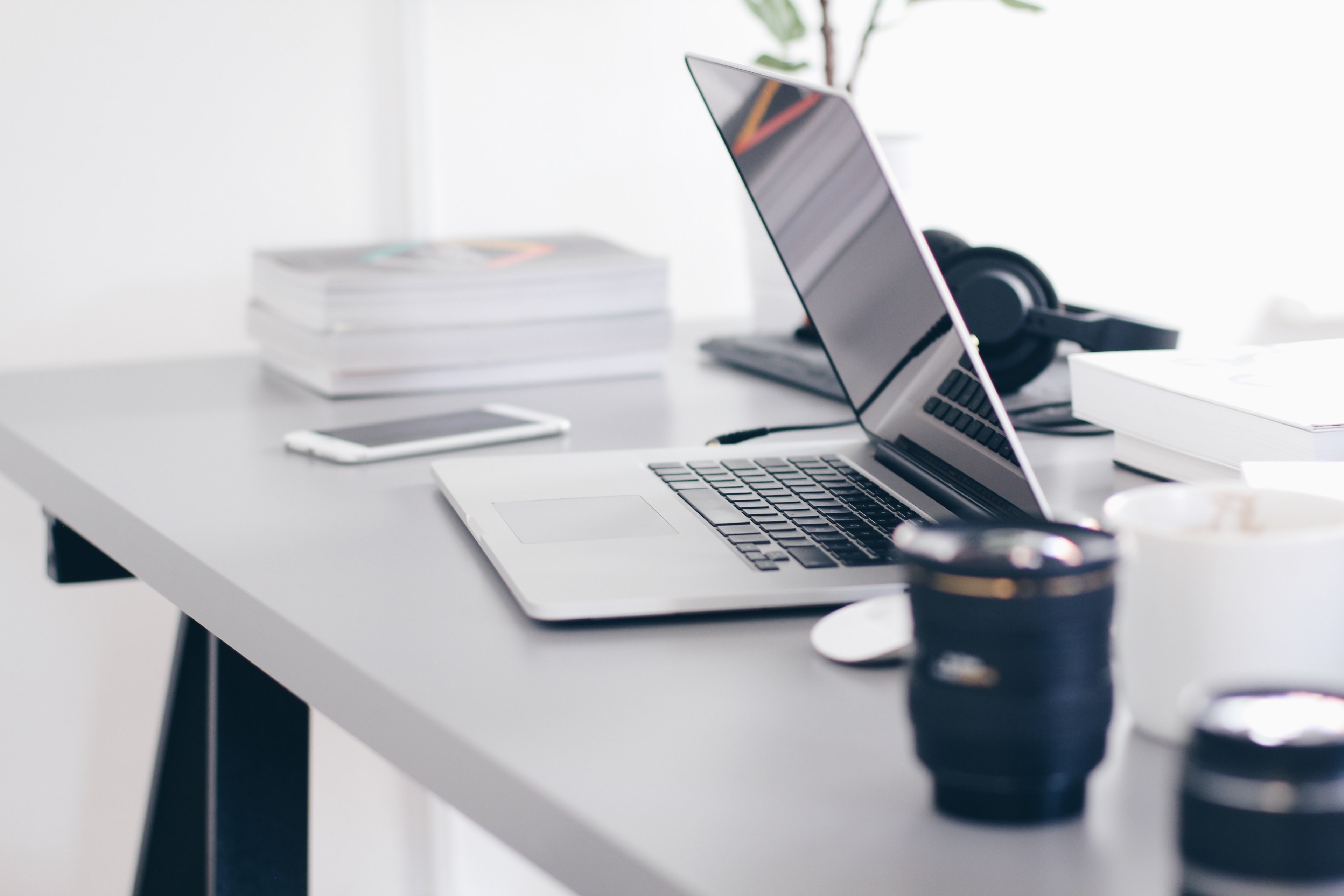 a half closed laptop on a busy desk with headphones camera lenses and books, focus 4k, HD Wallpaper