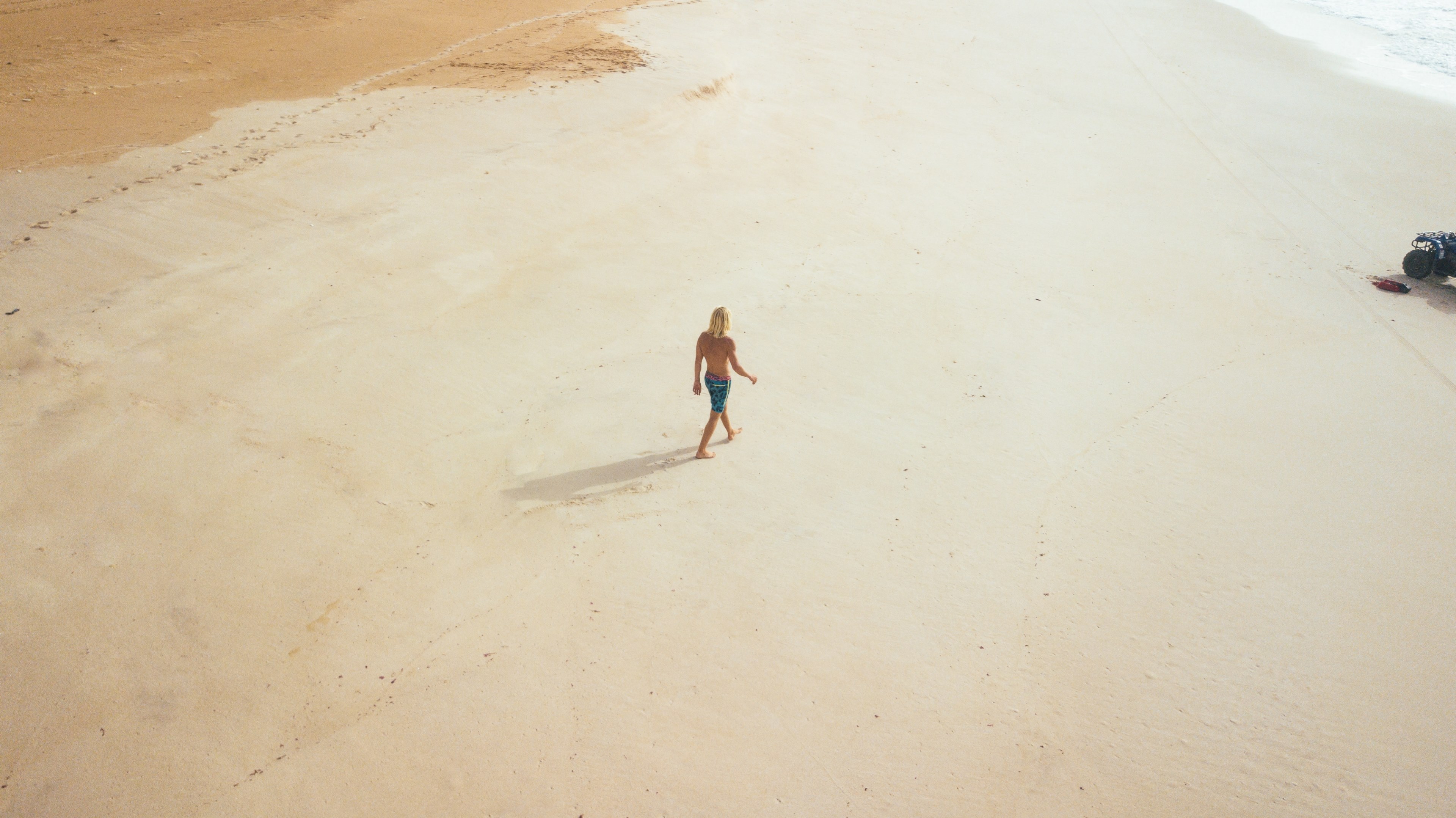 a high angle shot of a person walking along an empty beach on a sunny day, lost in the marocco 4k, HD Wallpaper