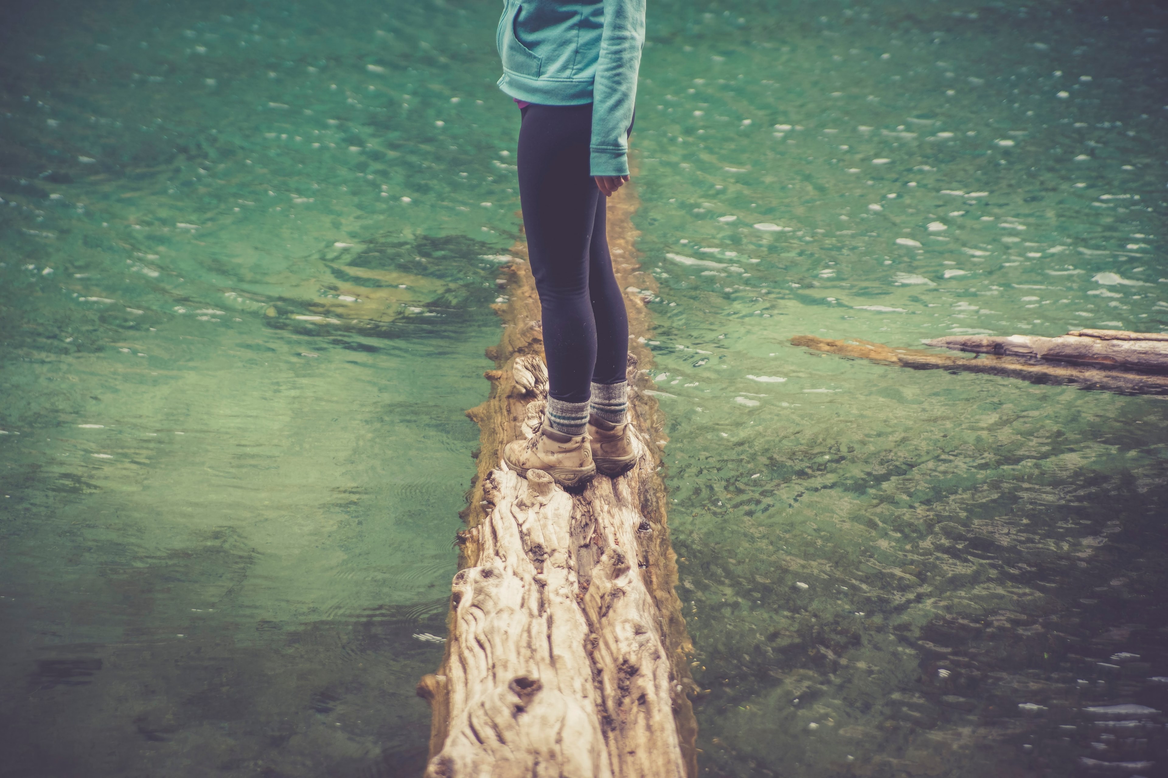 a woman standing on a log submerged in a lake, woman on a log in a lake 4k, HD Wallpaper