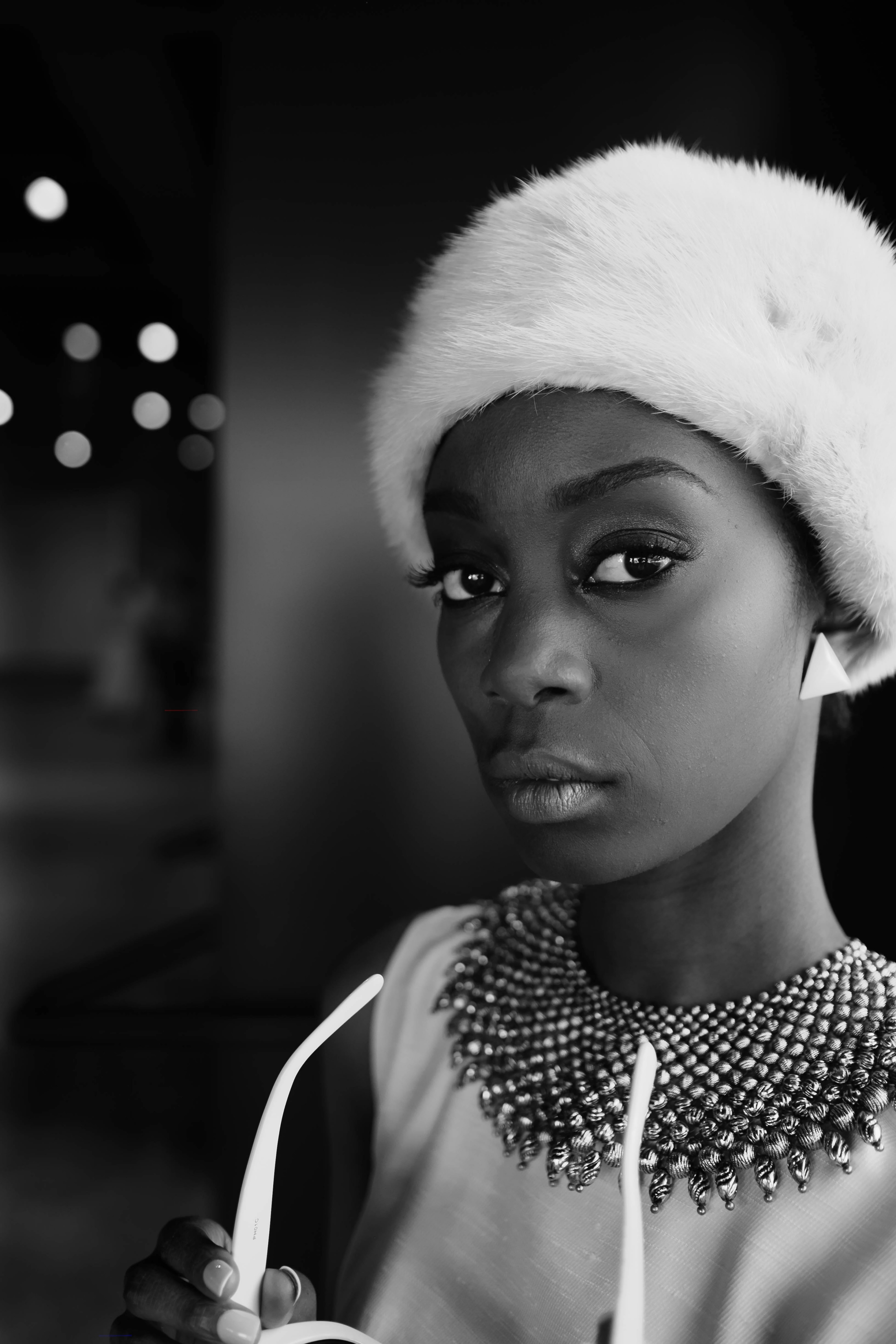 a black and white shot of a young woman in a furry cap, woman in white with bokeh 4k, Phone HD Wallpaper