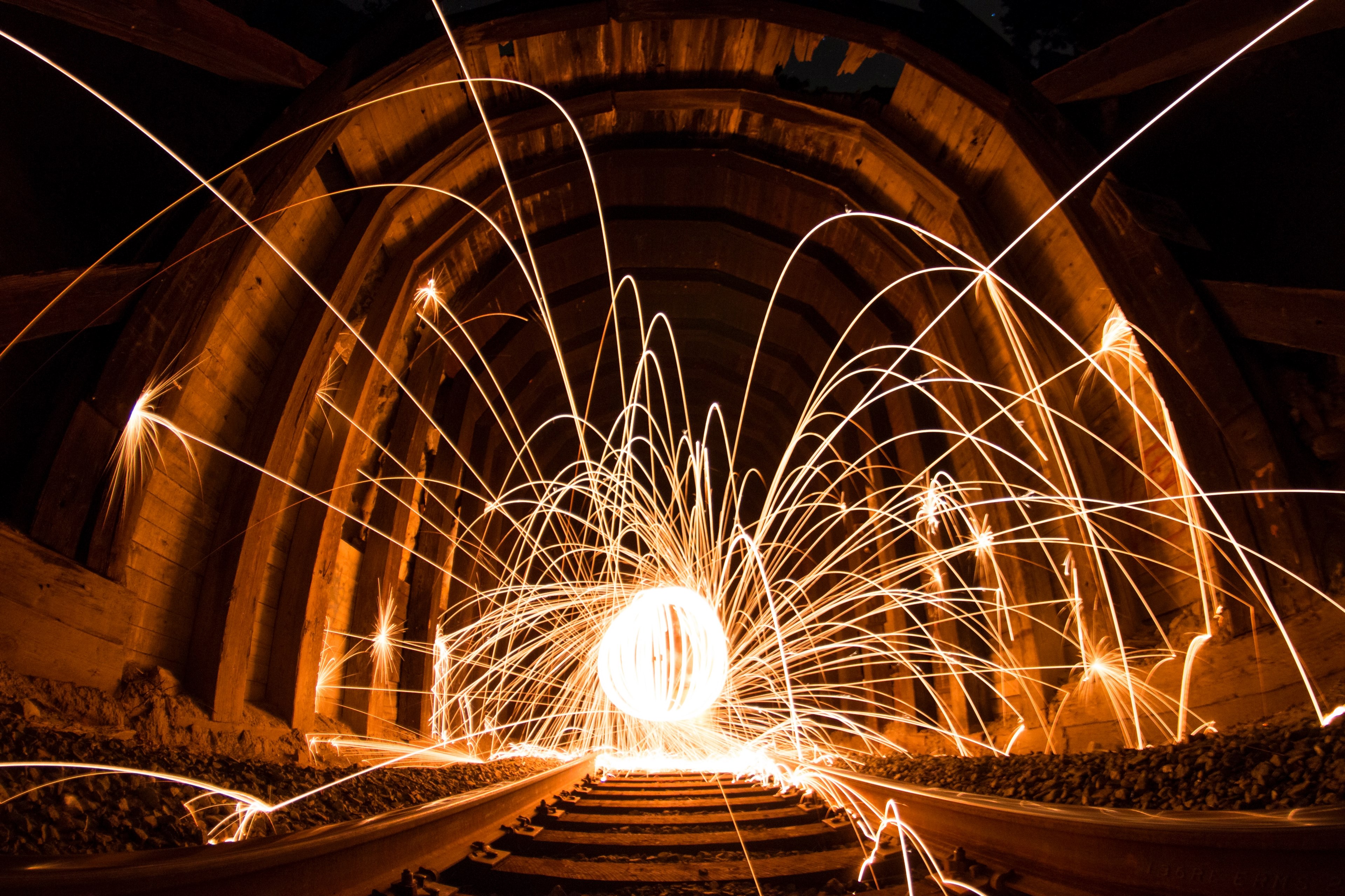a long exposure shot of steel wool light trails in an ironwood train tunnel, steel wool lightpainting in a train tunnel 4k, HD Wallpaper