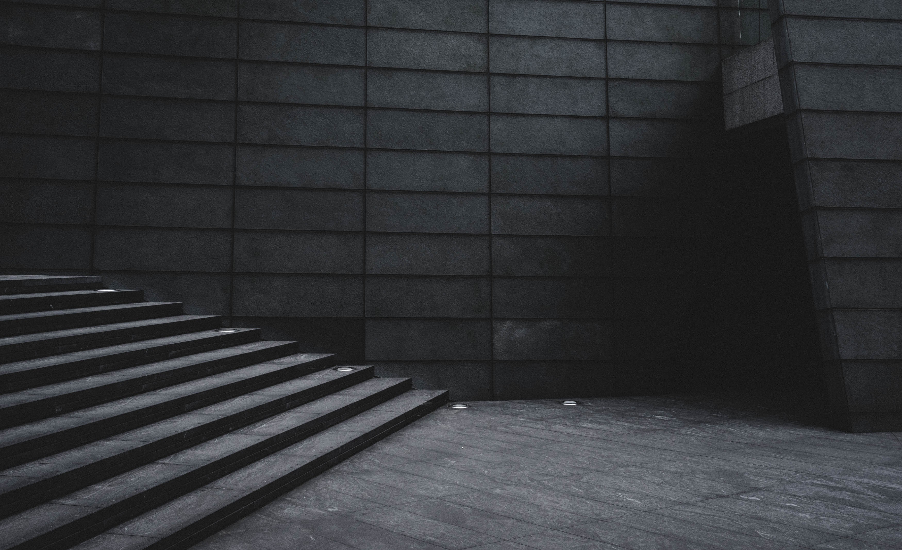 a dim shot of the bottom of a gray staircase in a concrete building, gloomy staircase 4k, HD Wallpaper