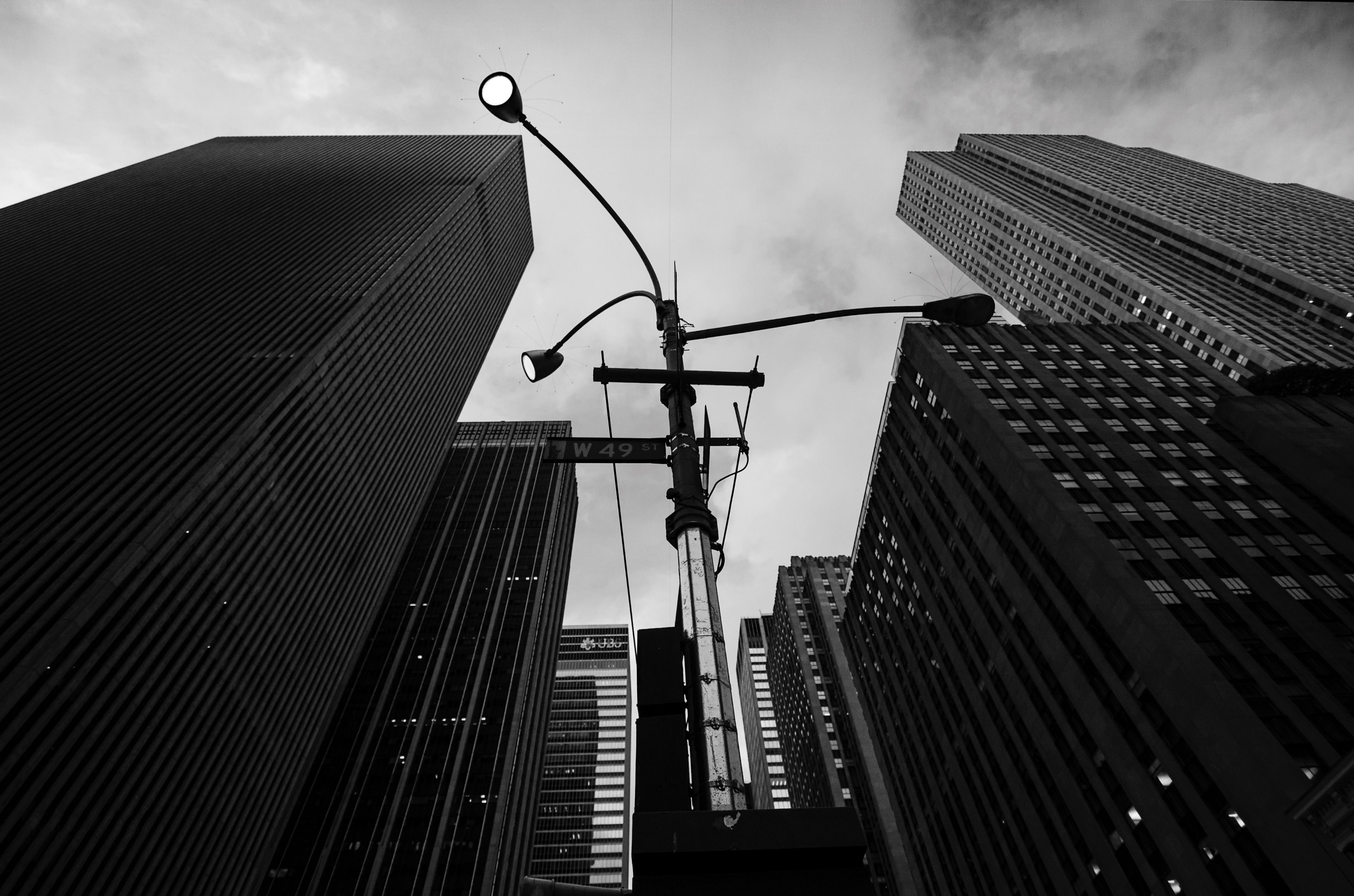 an urban street full of skyscrapers representing a business structured architectural design with a streetlight and a lamp post, skyscrappers and lamp post 4k, HD Wallpaper