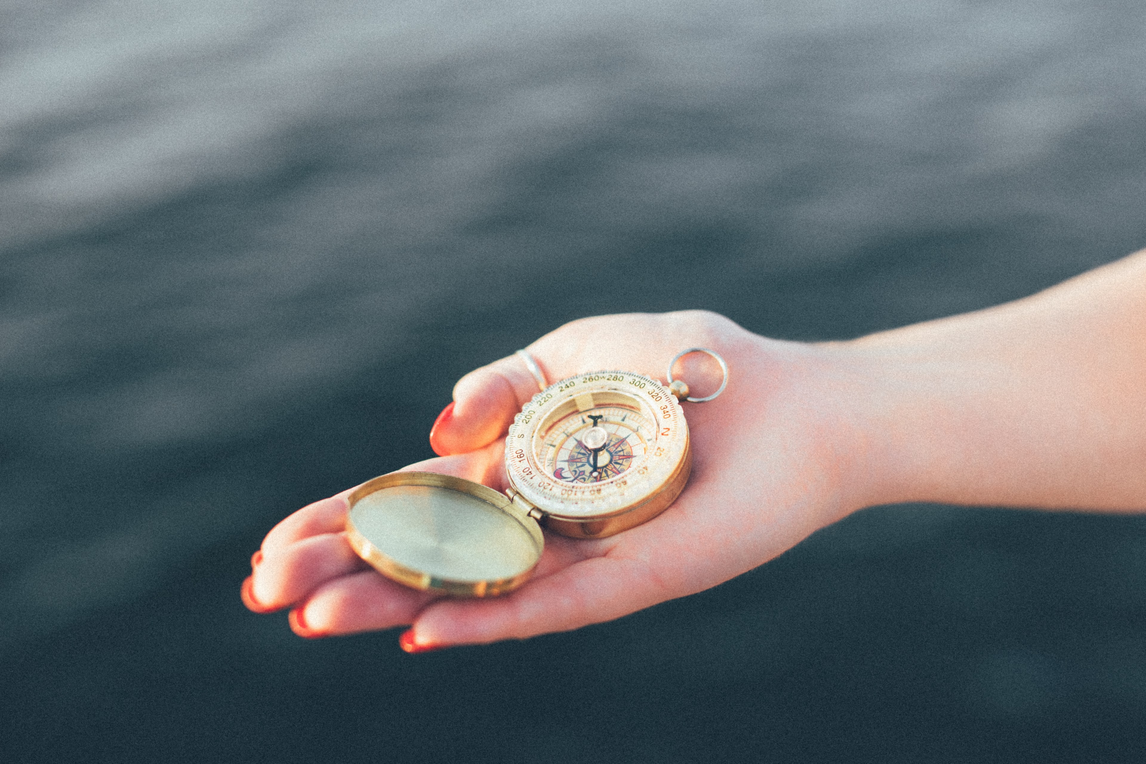 compass hand navigational instrument and water 4k, HD Wallpaper