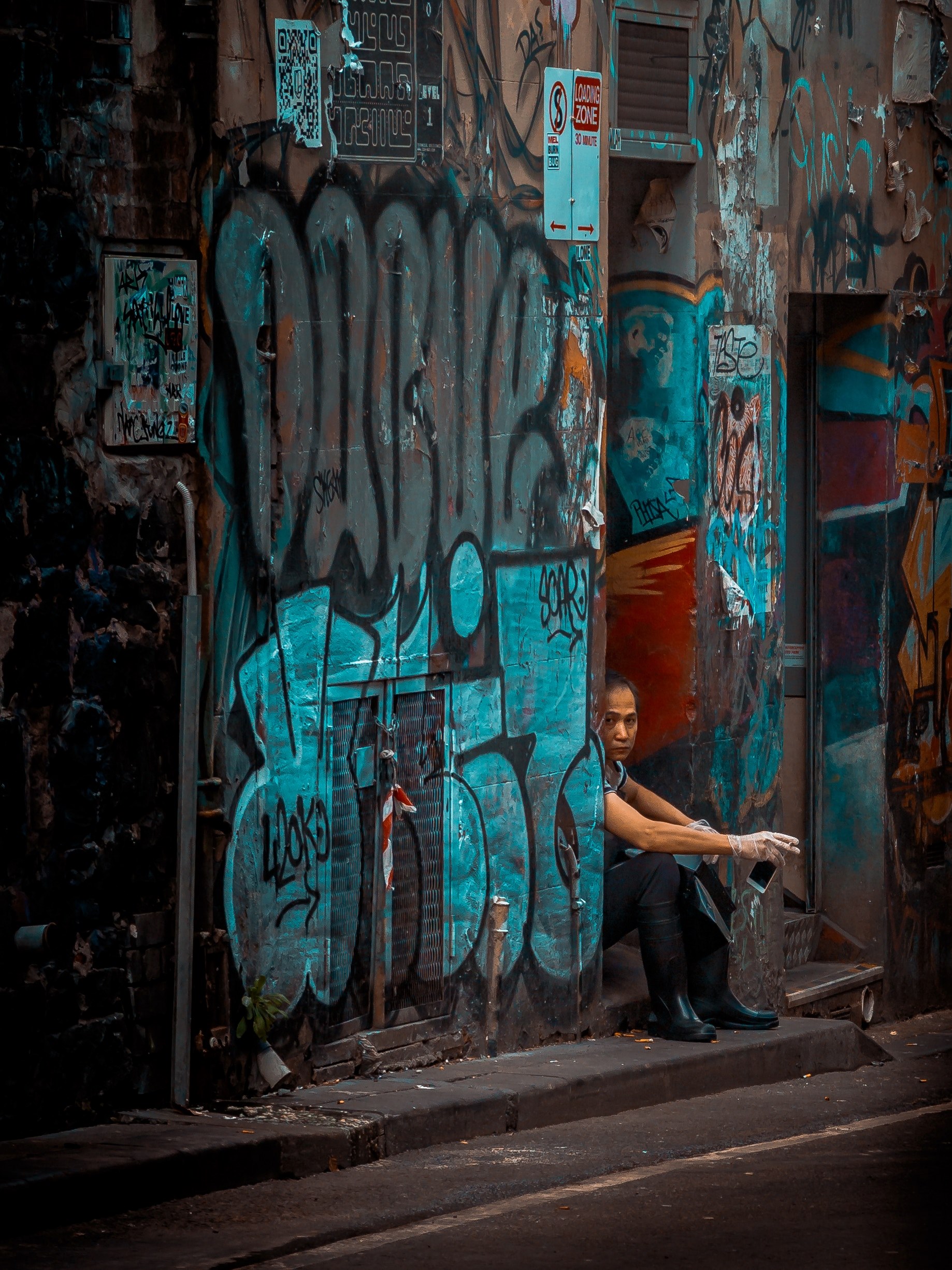 woman sitting in doorway smoking with blue colored graffiti covered walls in melbourne alley, woman smoking in alley 4k, Phone HD Wallpaper