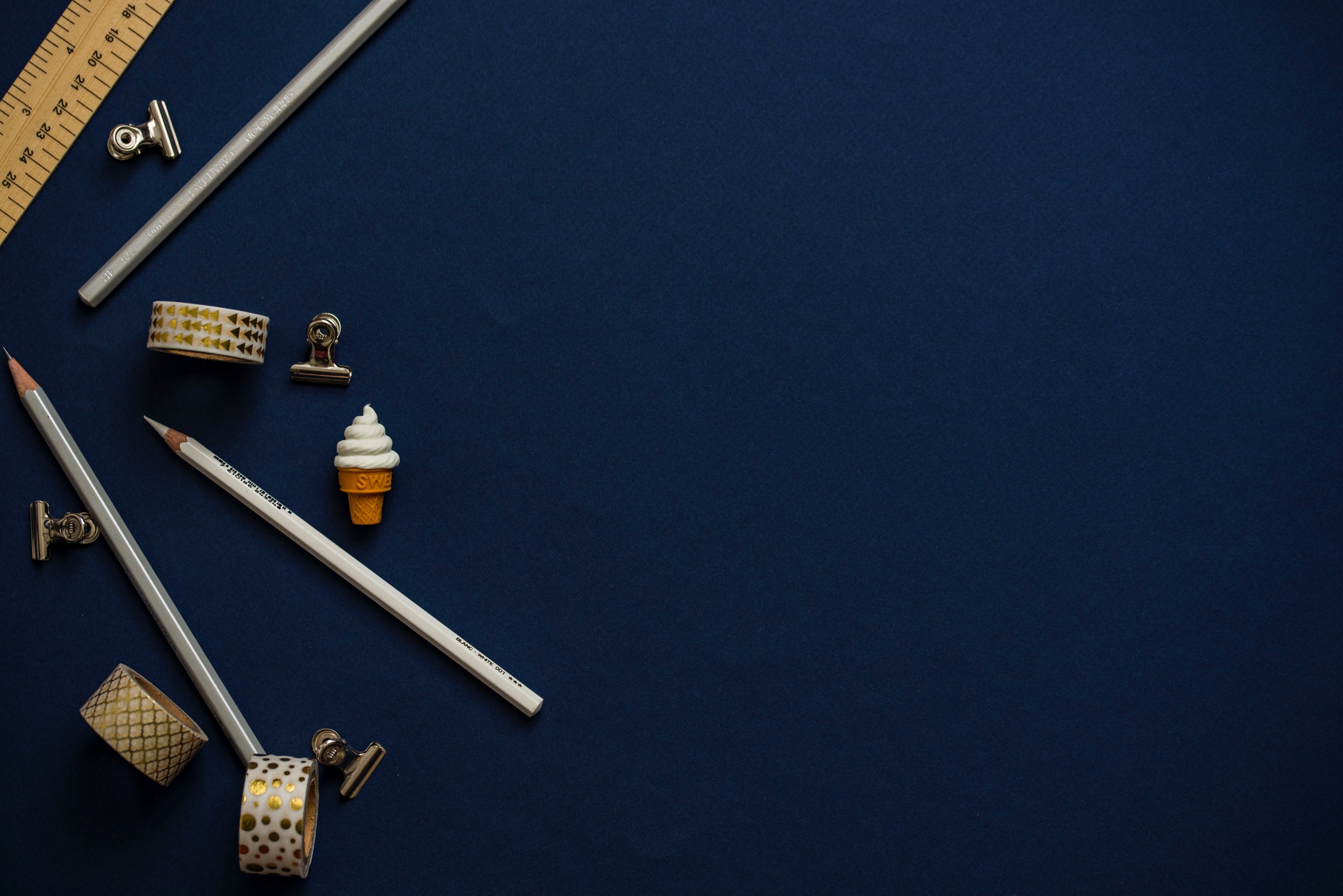an overhead shot of pencils a ruler scotch tape and bulldog clips on a dark blue surface, coloured pencils 4k, HD Wallpaper