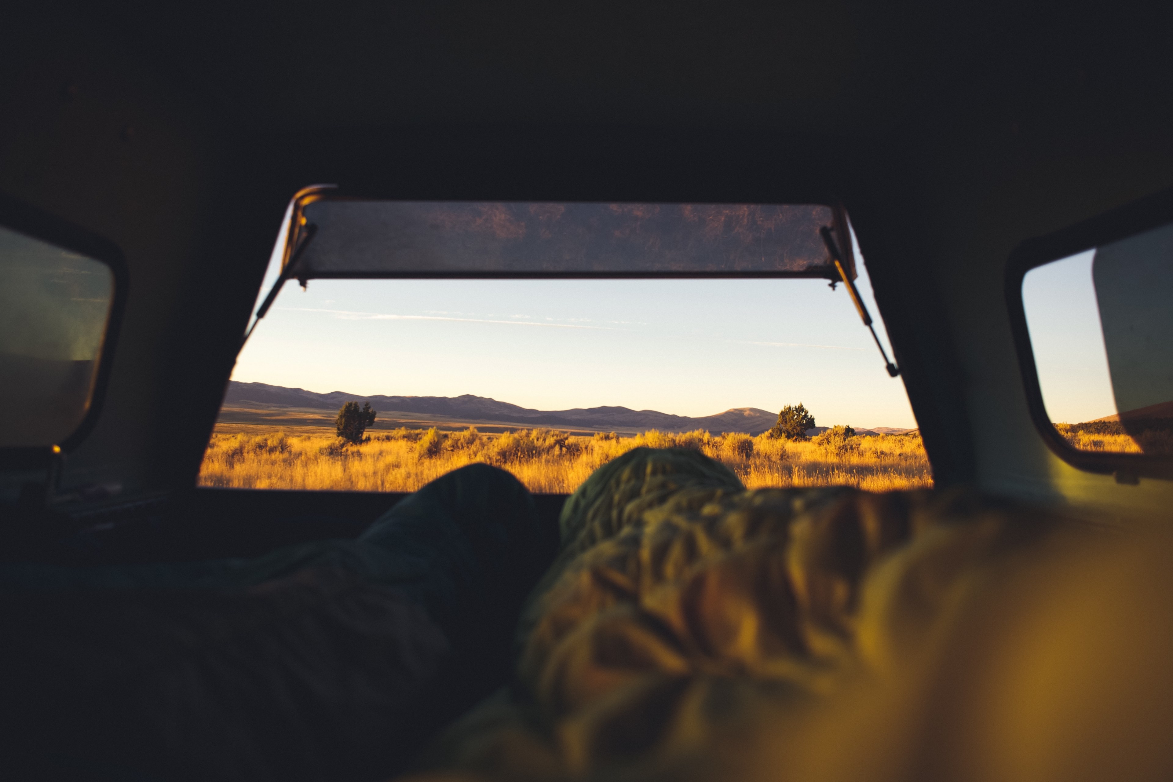 two campers lying in the back of an off road vehicle parked in the middle of the wilderness, early starts 4k, HD Wallpaper