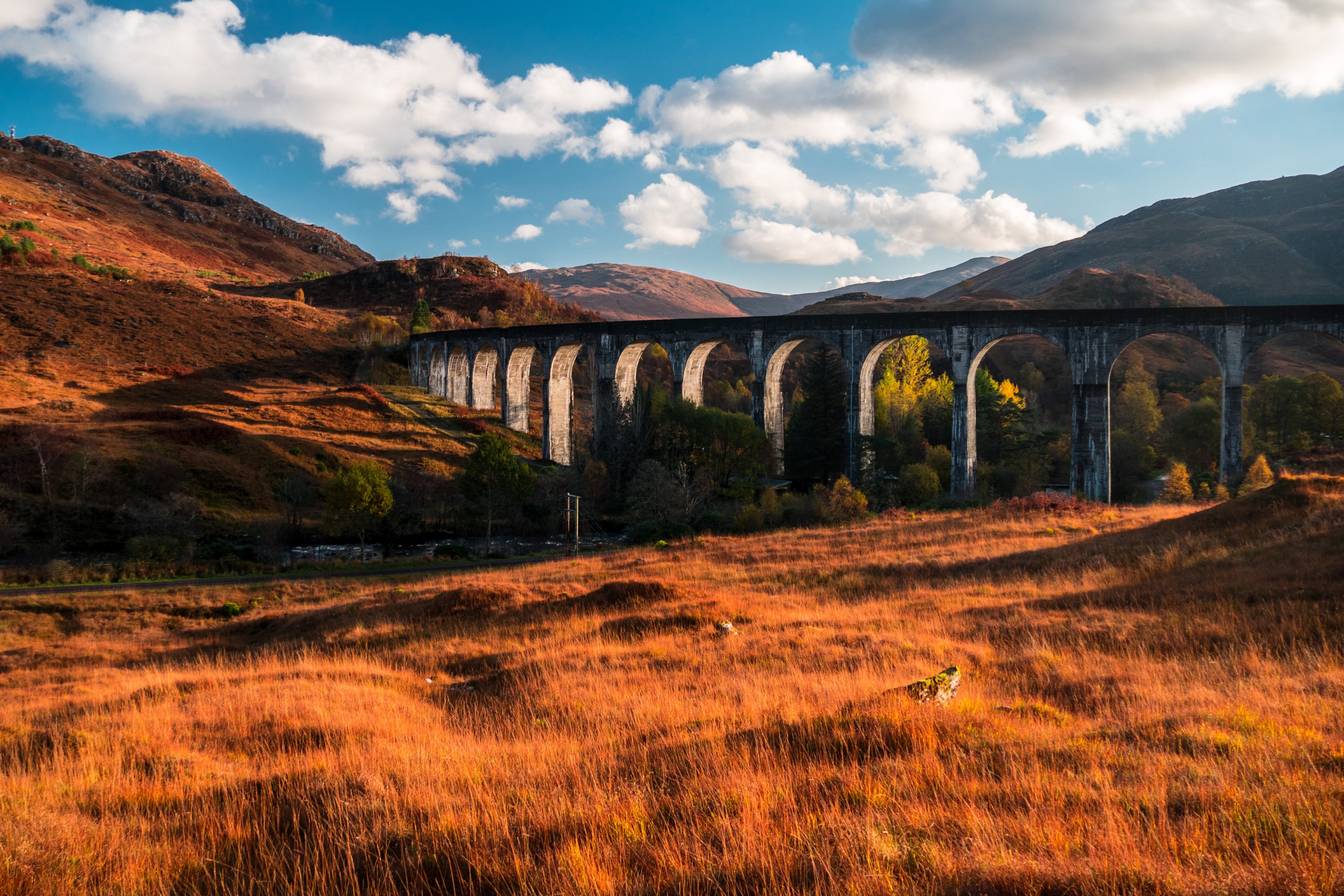 a concrete viaduct running through orange hilly grasslands on a sunny afternoon, viaduct in the autumn 4k, HD Wallpaper