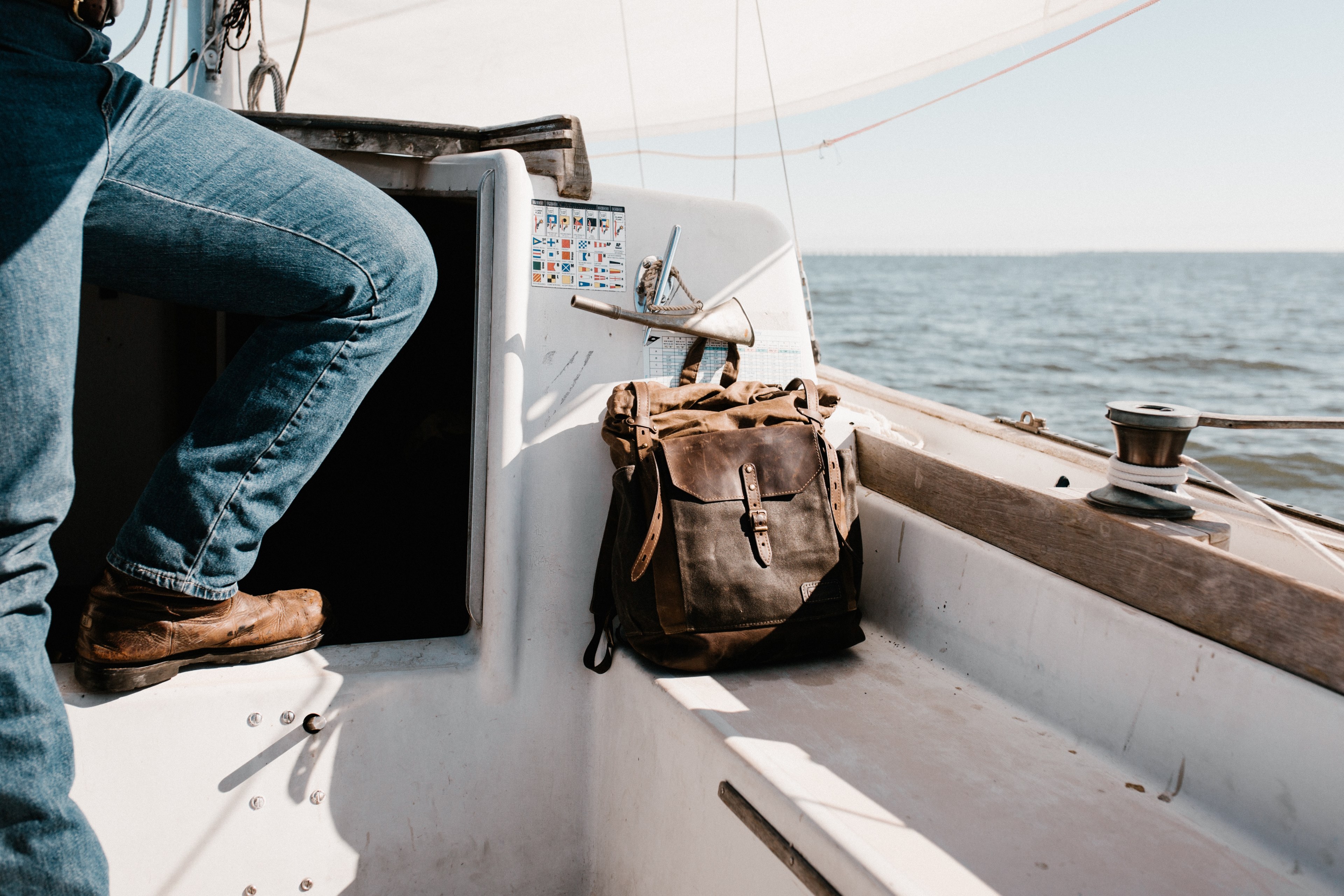 a man riding the waters in his sailboat on an ocean near norfolk, searching at sea 4k, HD Wallpaper
