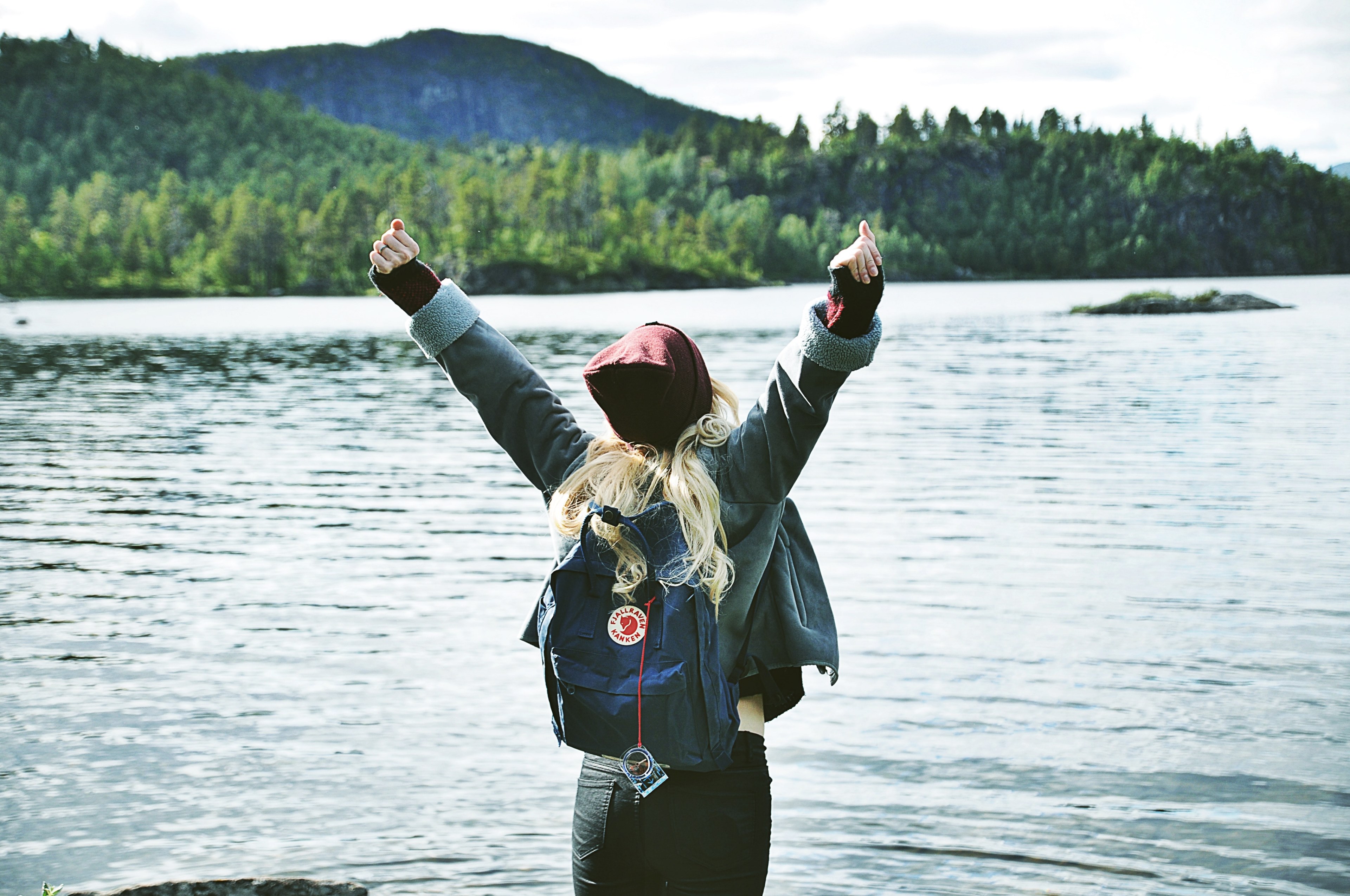 a backpacking woman stretching her arms up while looking out into the lake, _raise your hands 4k, HD Wallpaper
