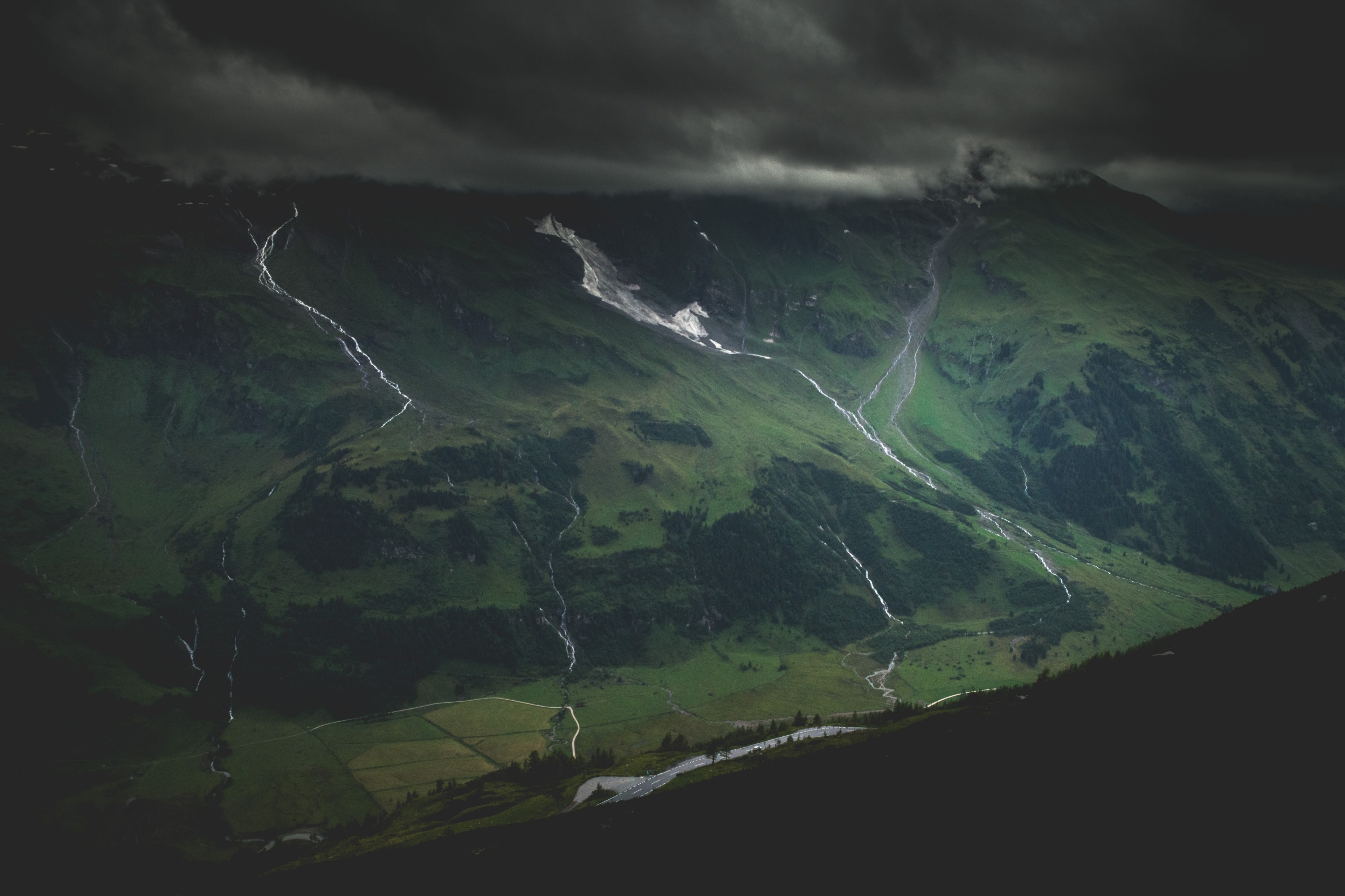 a steep green mountain valley under thick gray clouds, gray clouds over green valley 4k, HD Wallpaper