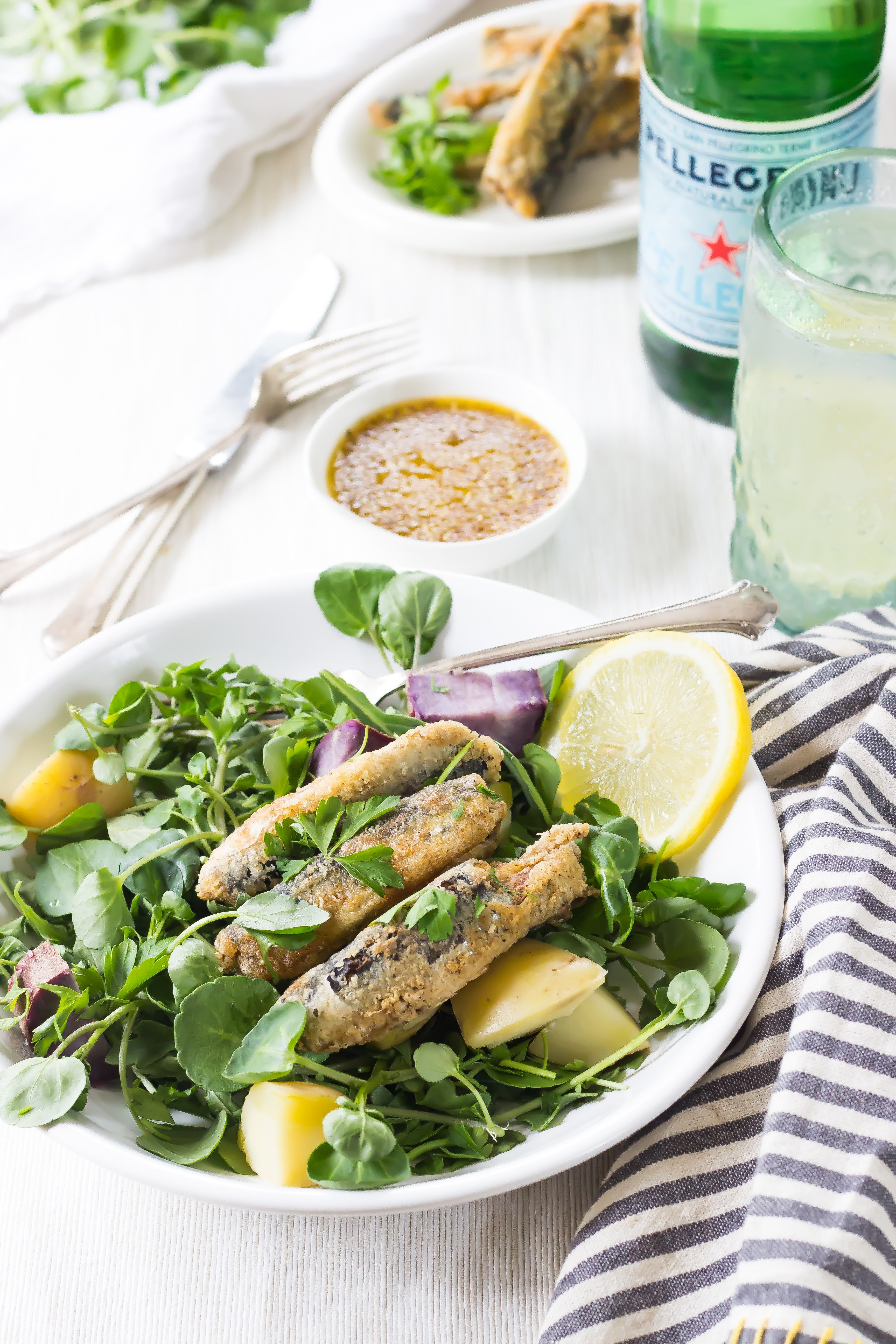 a dish with spinach fish and lemons on a set table, light salad for lunch 4k, Phone HD Wallpaper
