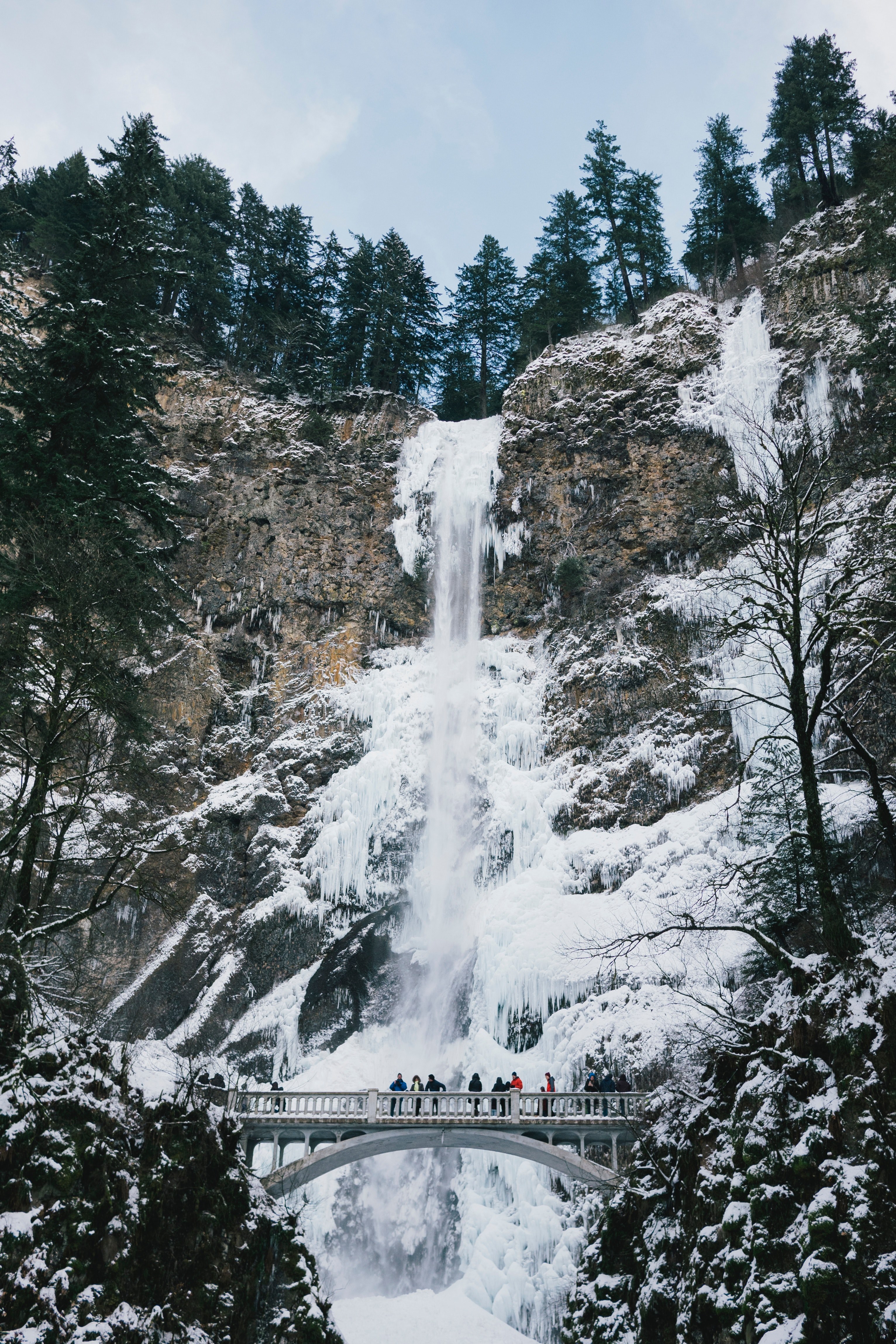 tourists on a white bridge near a tall waterfall on a cold winters day, bridge near a wintry waterfall 4k, Phone HD Wallpaper