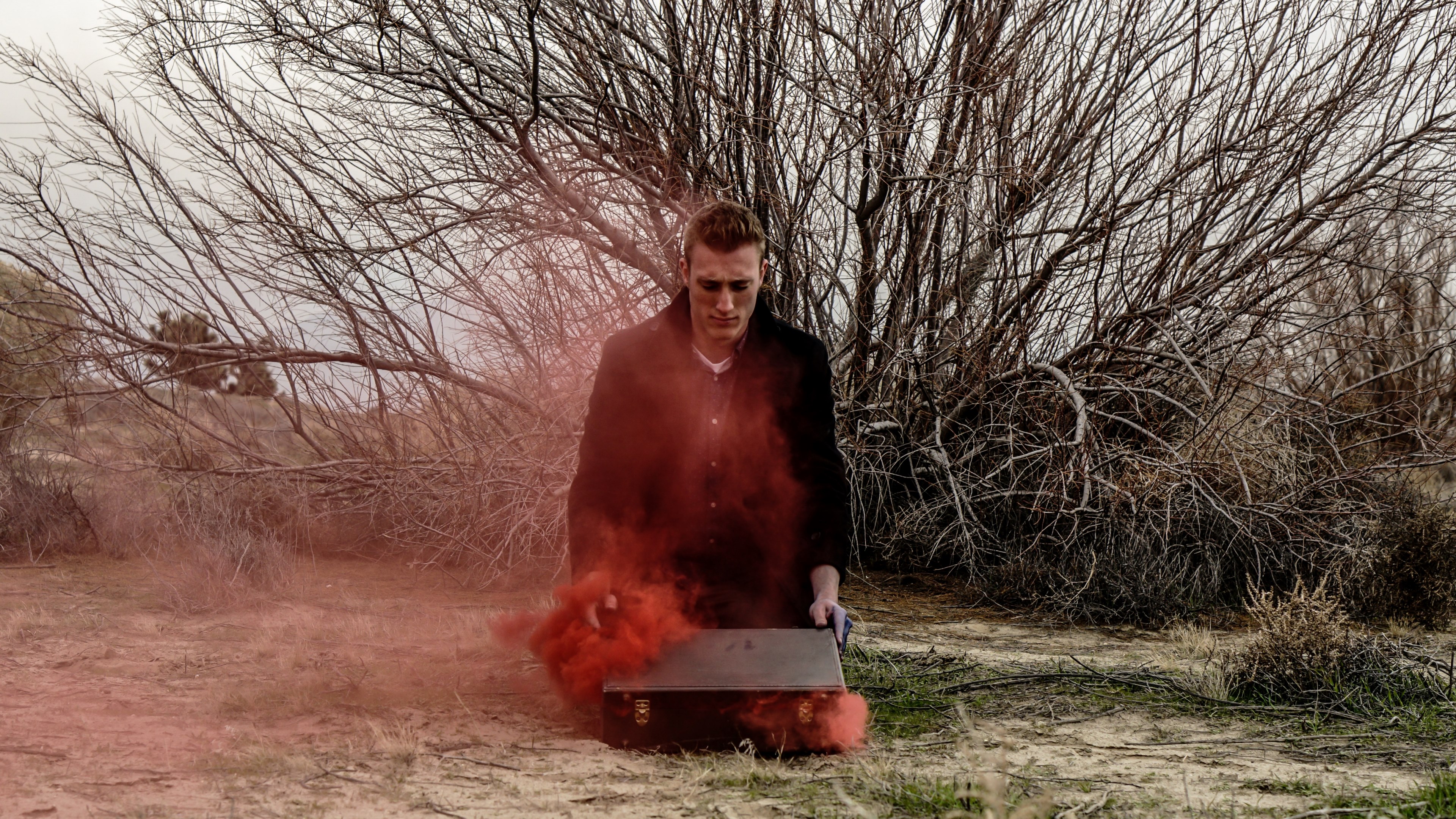 a man opening his suitcase on the ground as red smoke escapes it, _r e v e a l 4k, HD Wallpaper