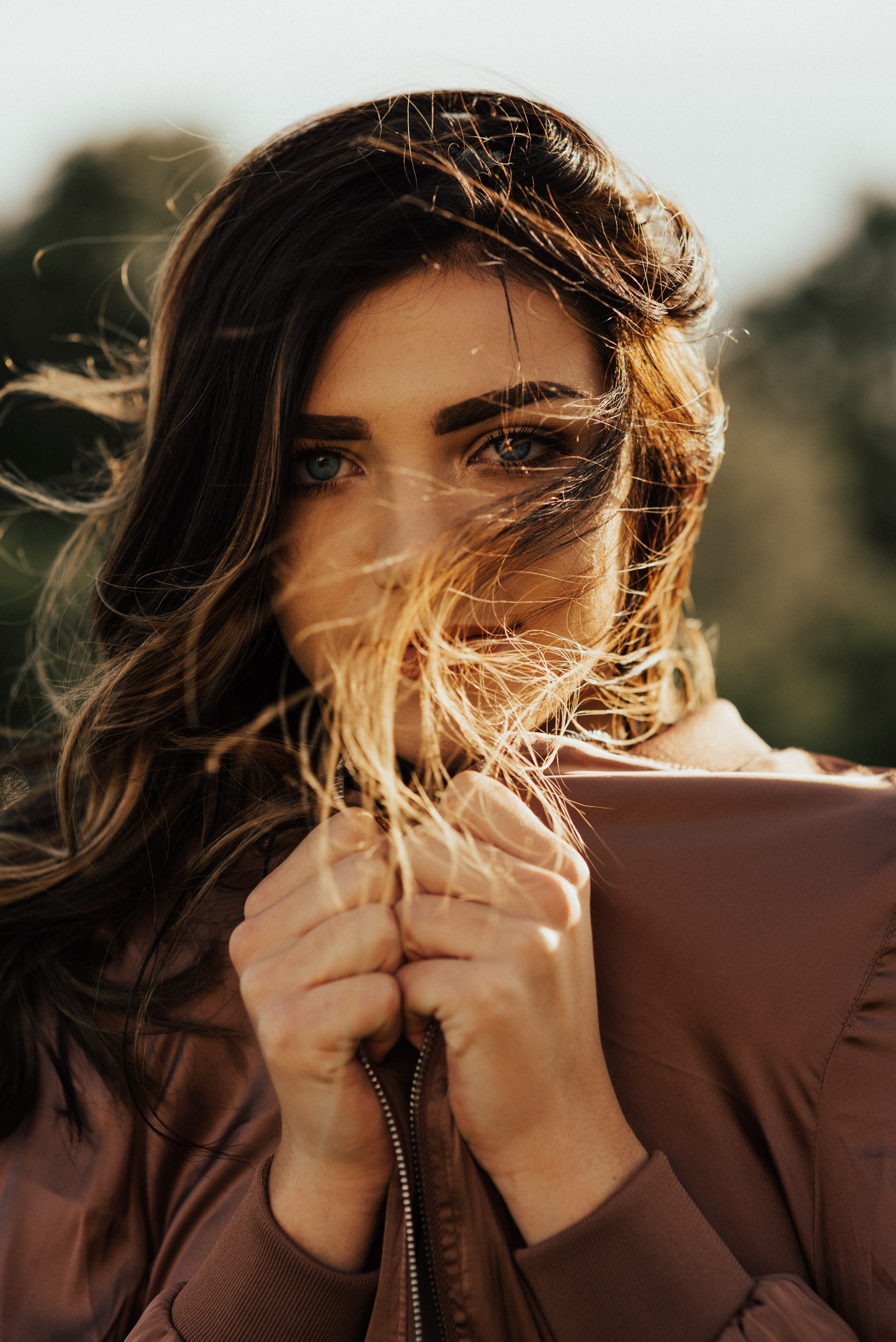 a woman in a brown jacket with her hair blowing in the wind in salt lake city, windblown 4k, Phone HD Wallpaper