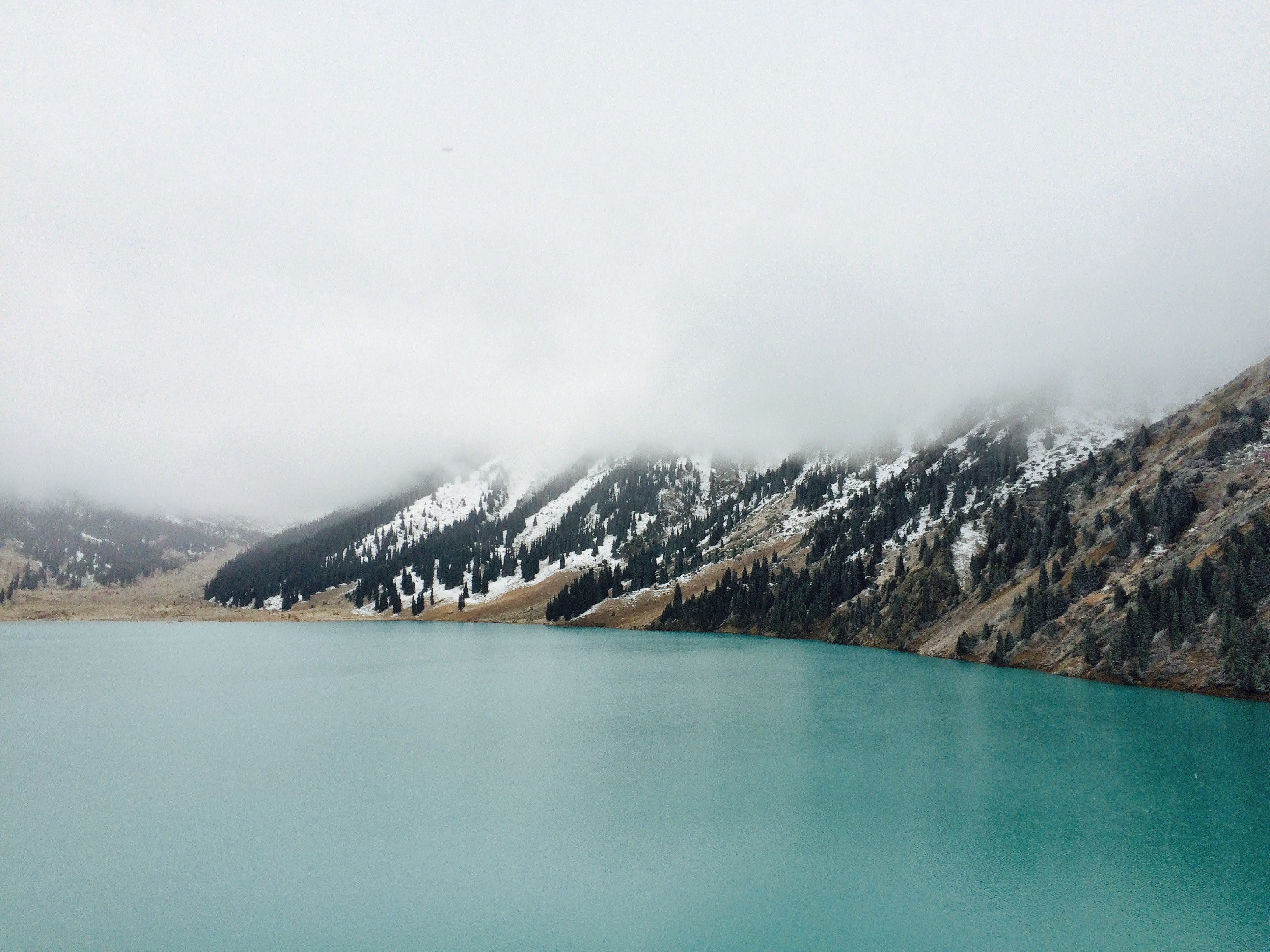 a mountain lake with snowy slopes covered in a thick layer of fog, mountain lake under dense mist 4k, HD Wallpaper