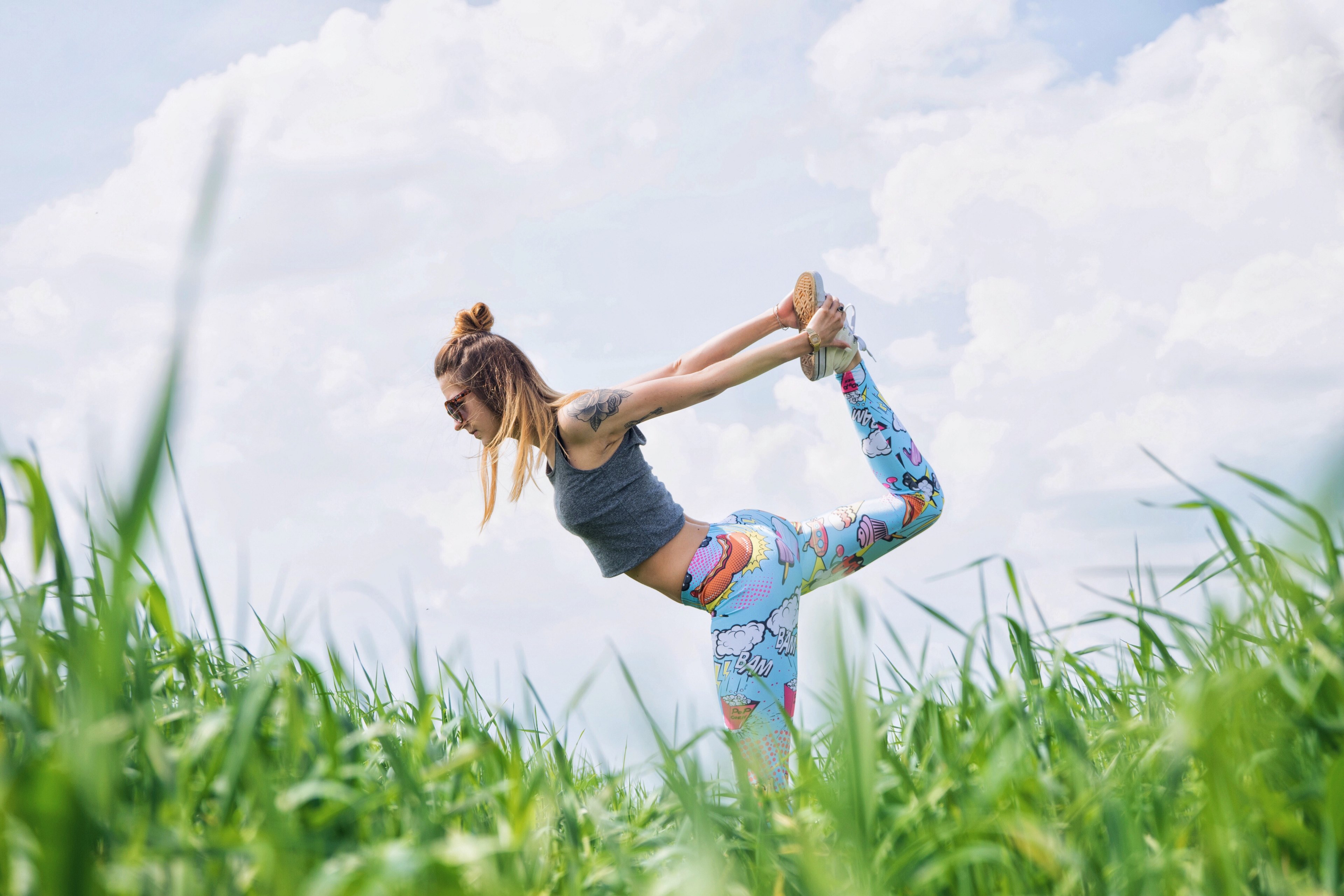 a woman wearing funky leggings doing yoga on the grass in karczewski, yoga time 4k, HD Wallpaper