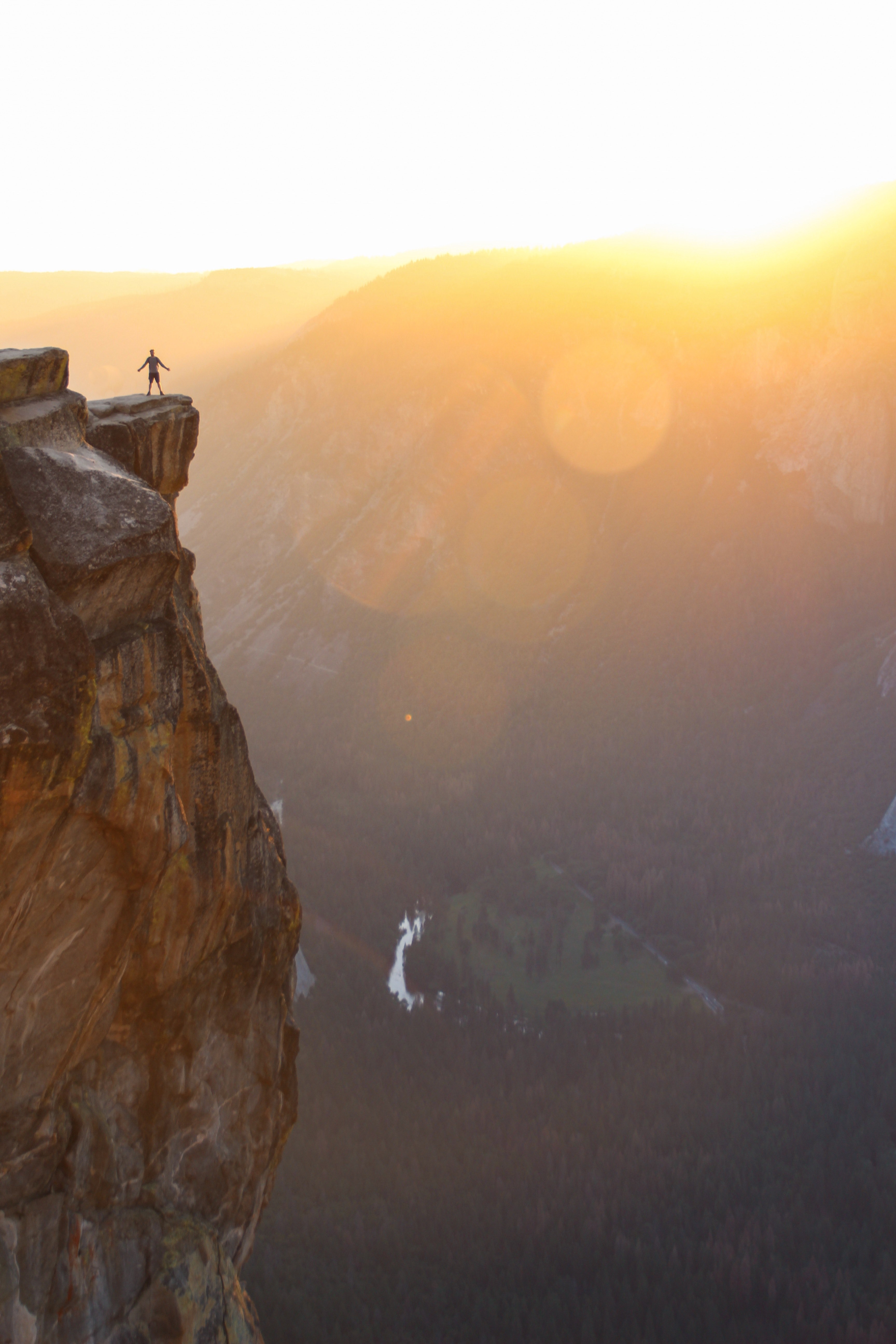 person with arms stretched wide standing by the ledge of a cliff during sunrise in yosemite valley, on top of the world 4k, Phone HD Wallpaper