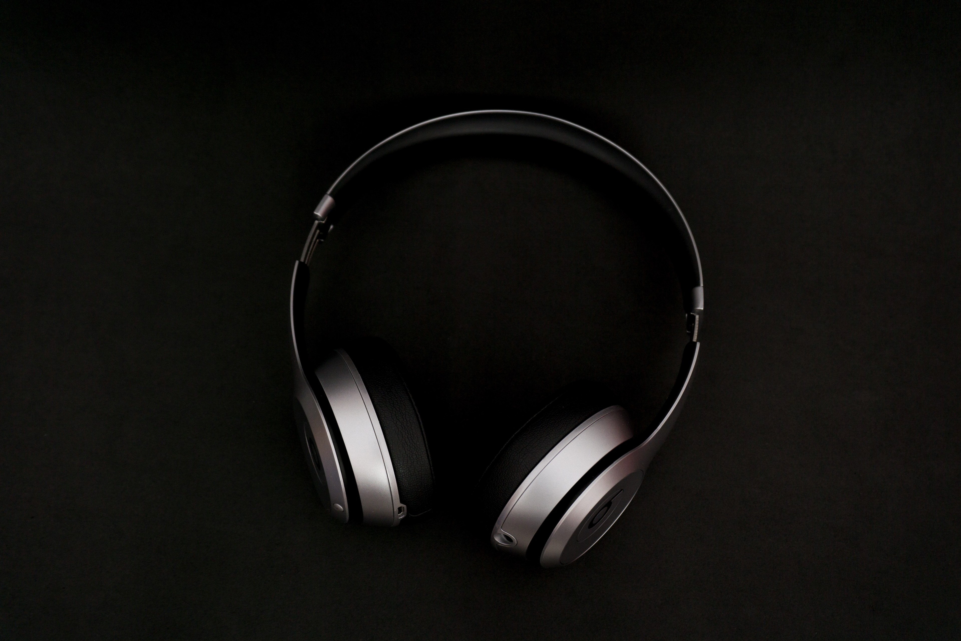 silver and black earphones in black background standing upright, beats solo2 wireless 4k, HD Wallpaper
