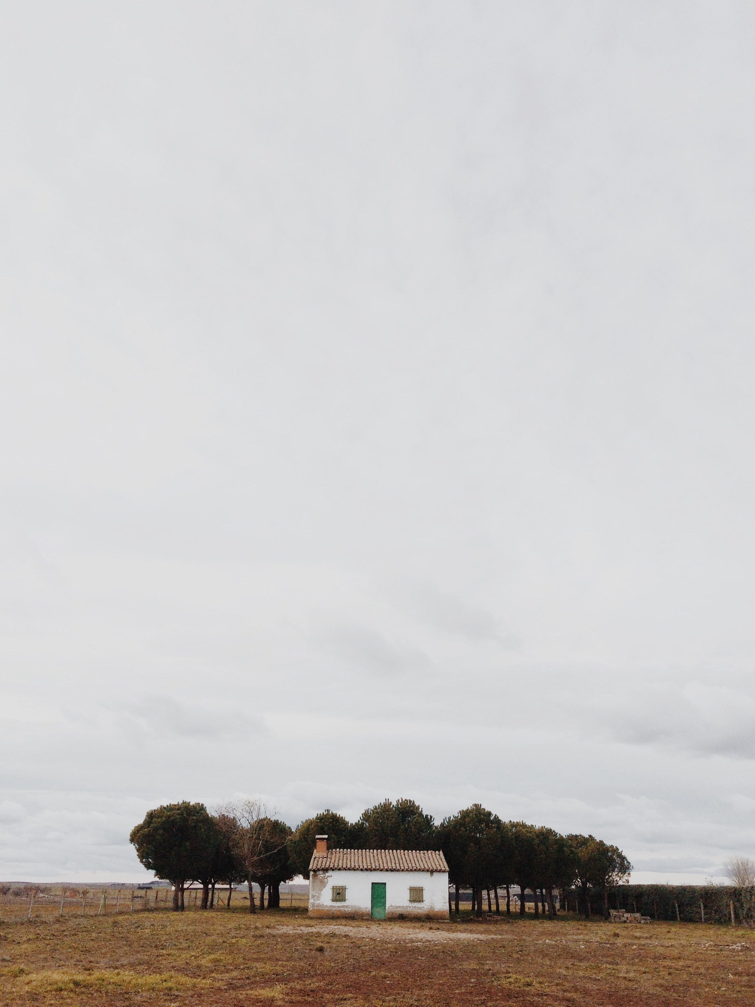 a small brick cottage with trees at the back in the middle of a dry plain, desolate brick cottage 4k, Phone HD Wallpaper