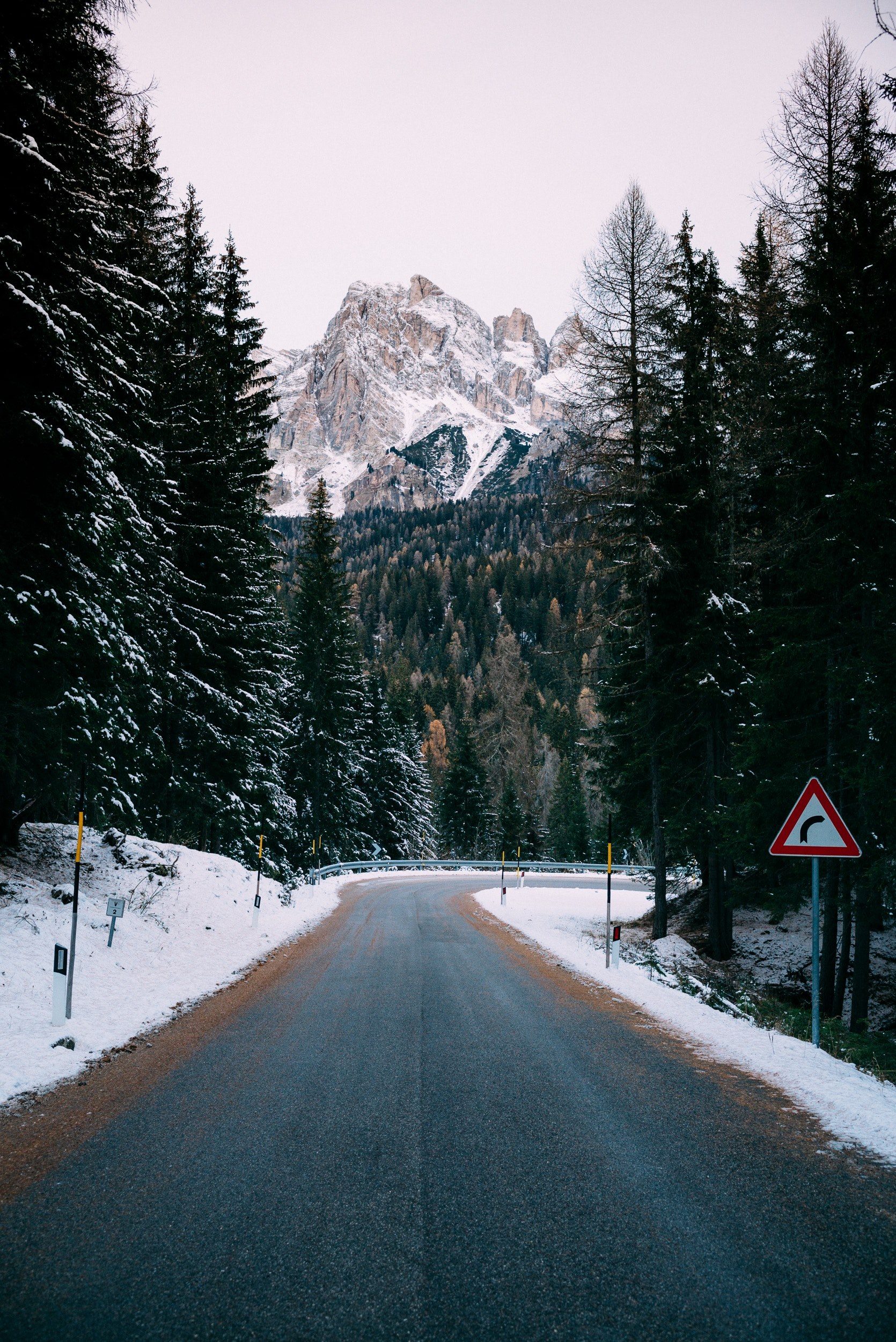 a curve in an empty road on a snowy day in the dolomites, somewhere in the dolomites 4k, Phone HD Wallpaper