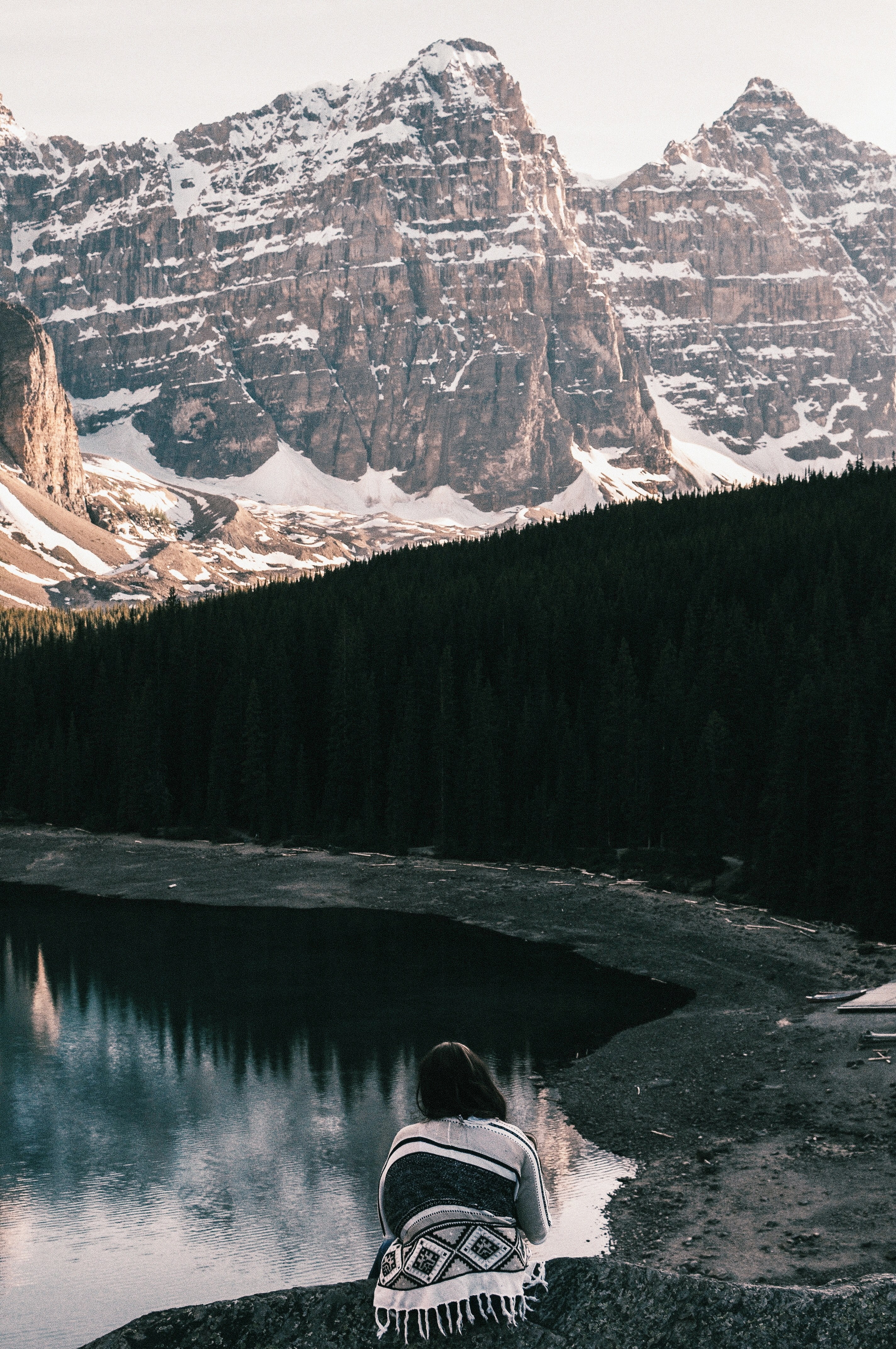 woman looks out over moraine lake snowy mountain and evergreen trees, woman looks out at moraine lake 4k, Phone HD Wallpaper