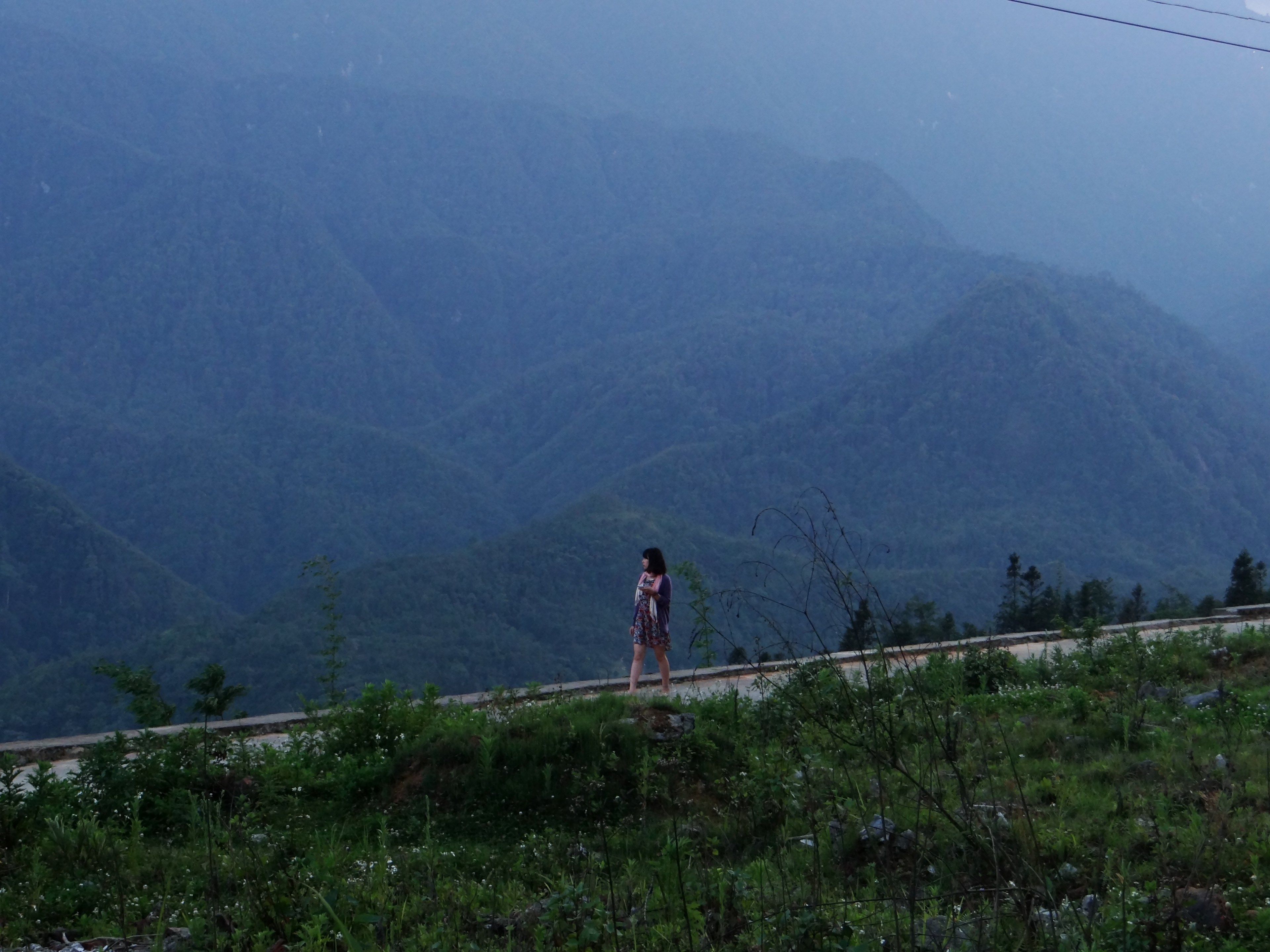 a dark haired woman walking across a path with lush undulating hills behind her, a walk over the green hills 4k, HD Wallpaper