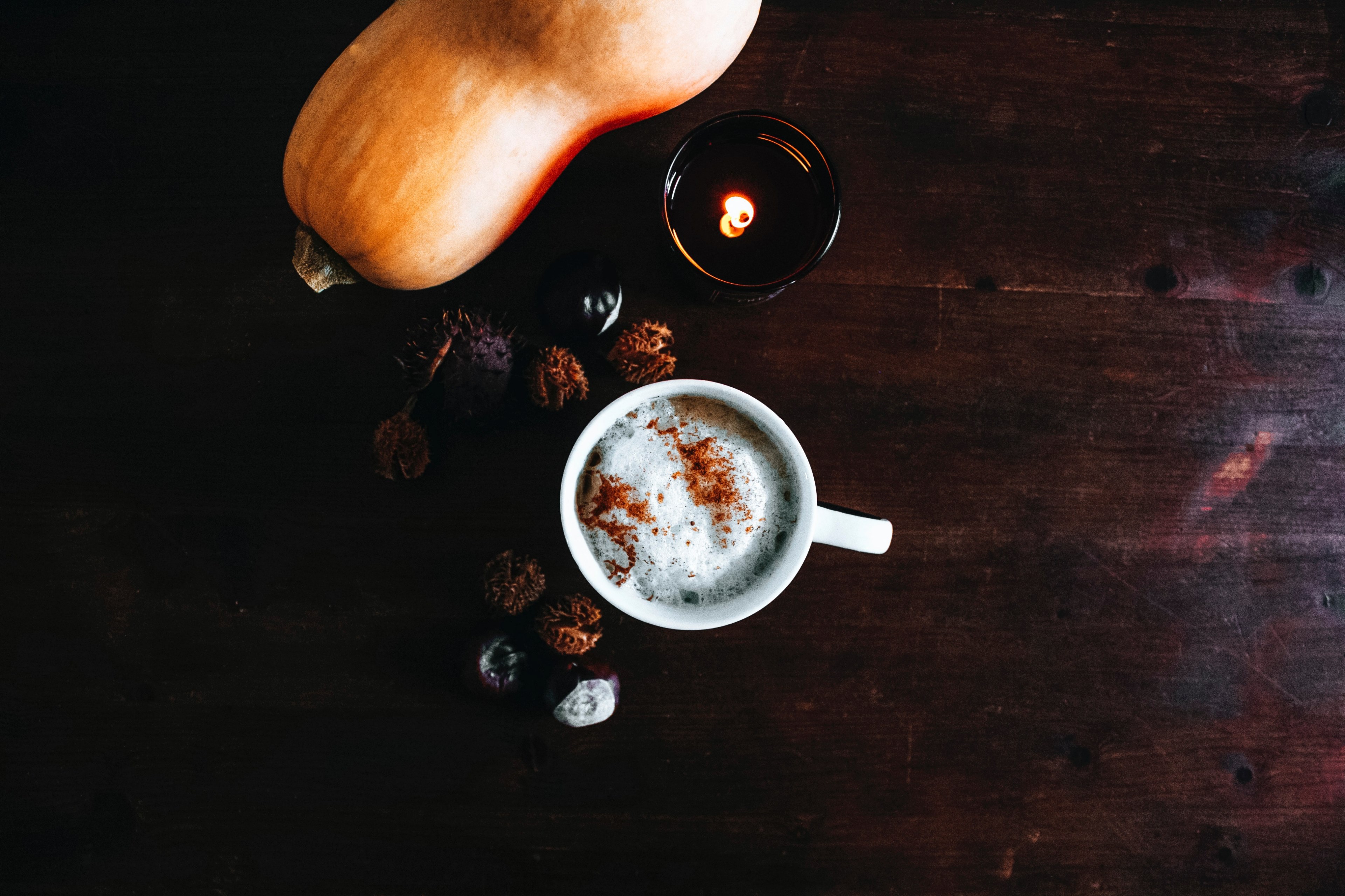 a mug of coffee spiced with cinnamon beside a squash and a candle, coffee next to candle 4k, HD Wallpaper