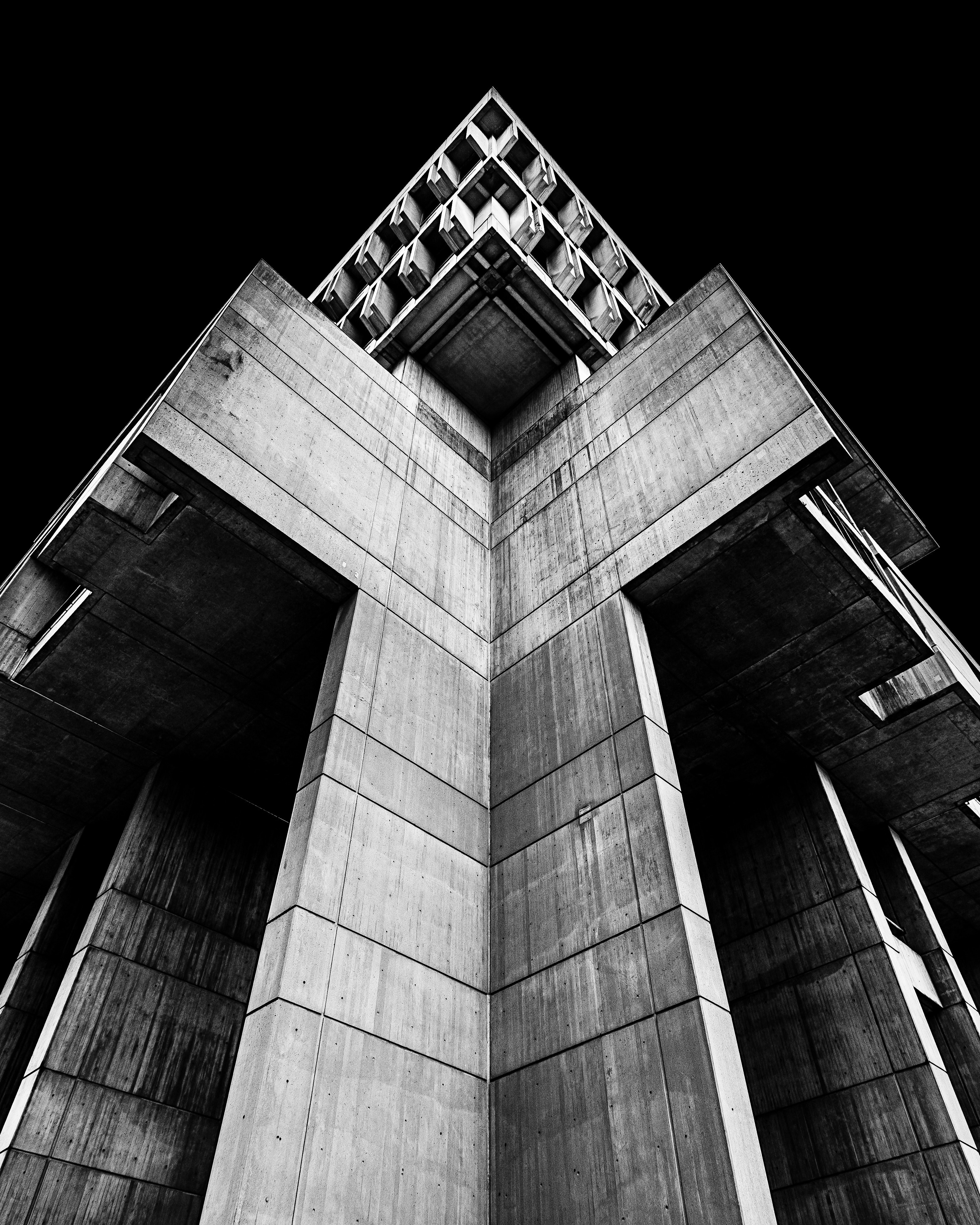 taken from the perspective of ground level a medium sized concrete building shadows over, black and white facade 4k, Phone HD Wallpaper