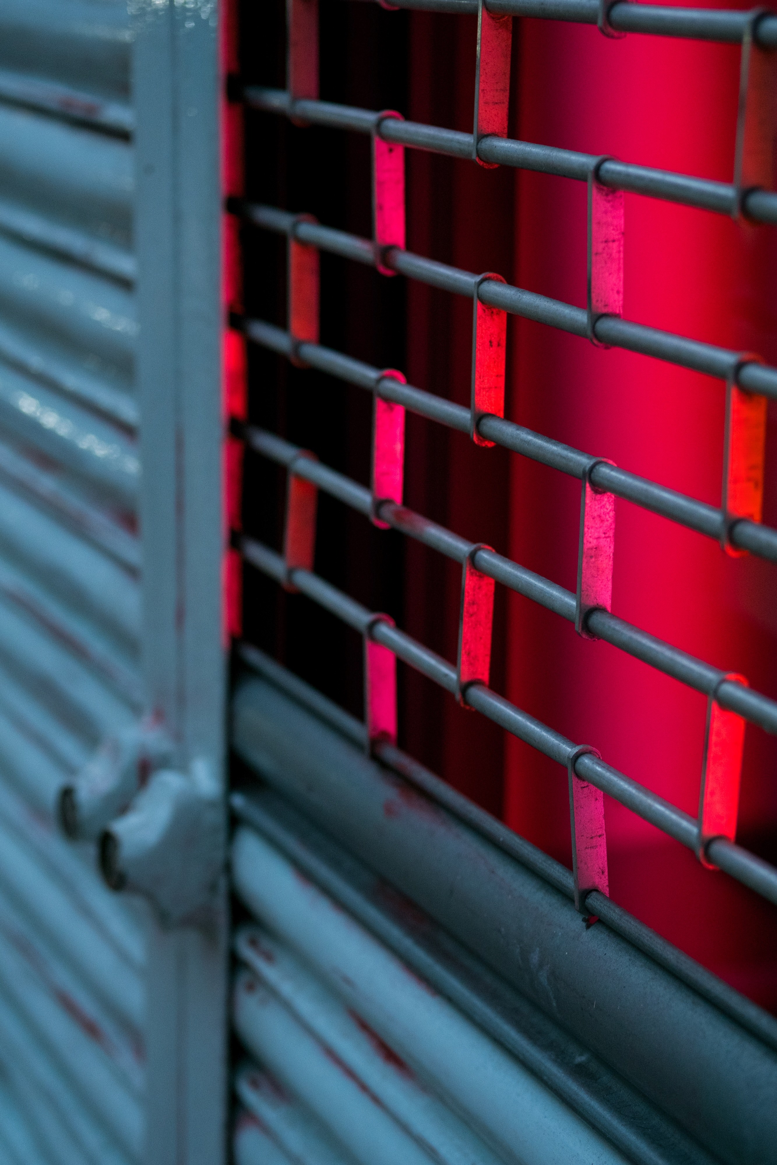 a red light inside of a room protected by a metal gate door, _metal fence gate door 4k, Phone HD Wallpaper