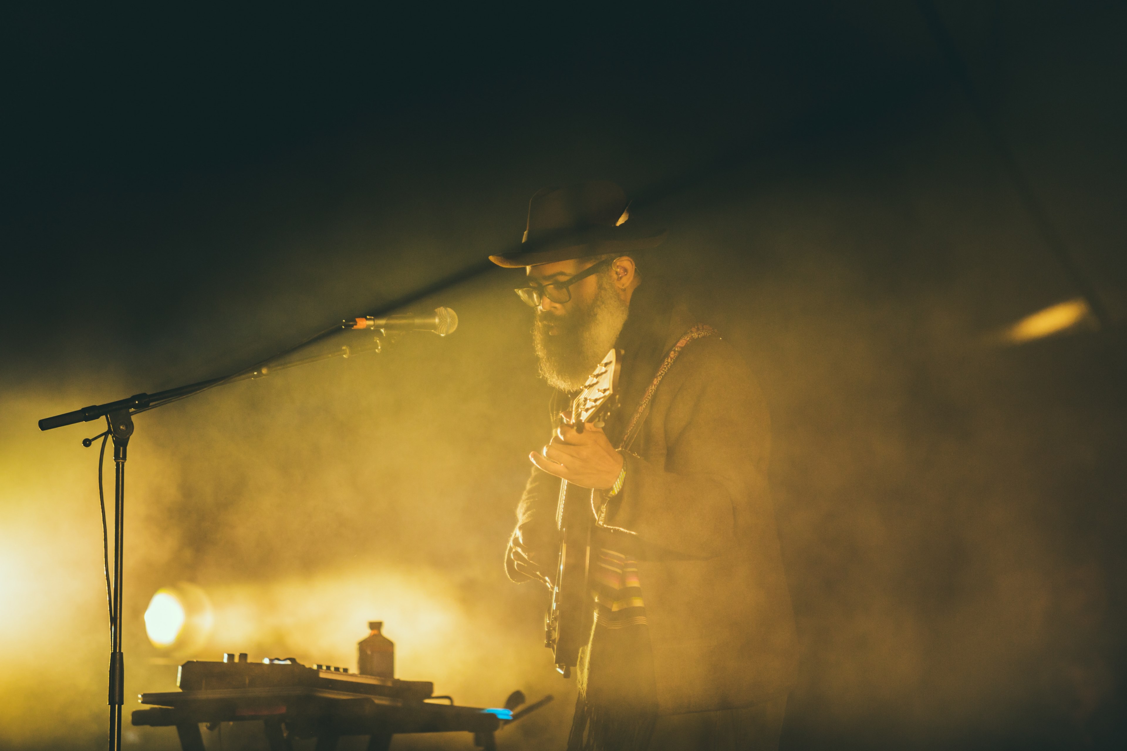 musician glows in yellow smoke and light on stage at a show, bearded guitar concert 4k, HD Wallpaper