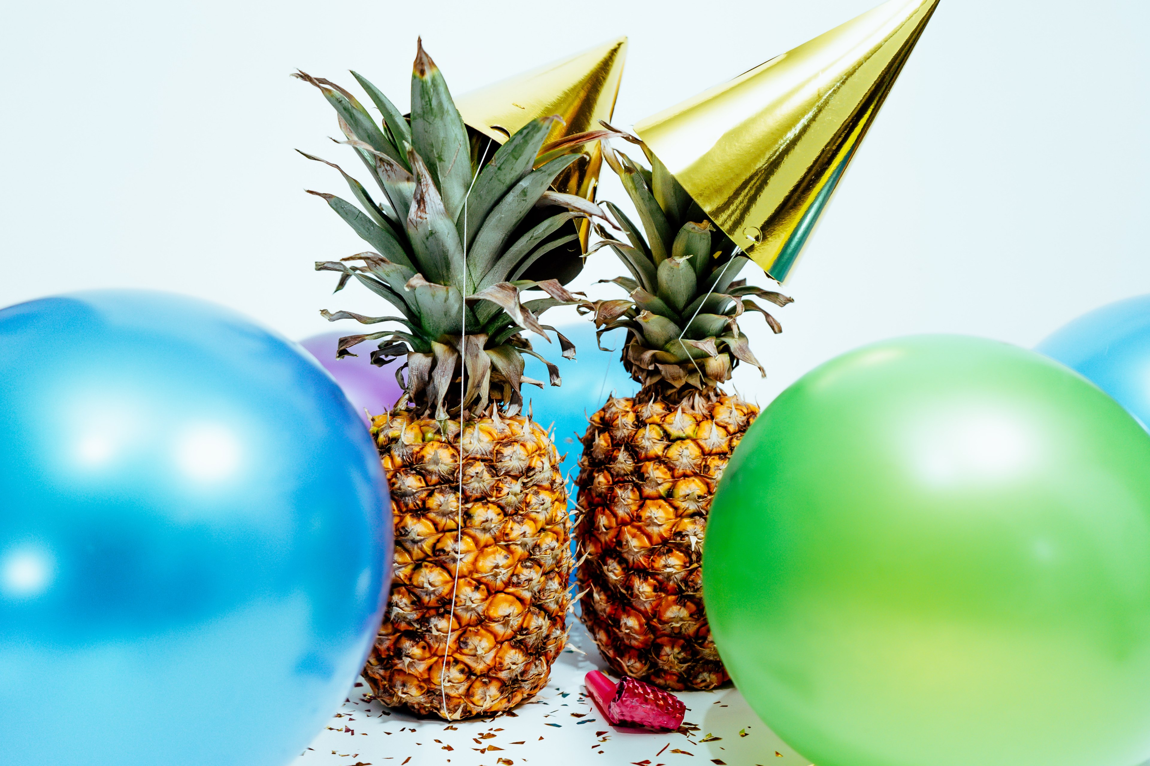 two pineapples wearing party hats surrounded by balloons by scott webb photography, good times 4k, HD Wallpaper