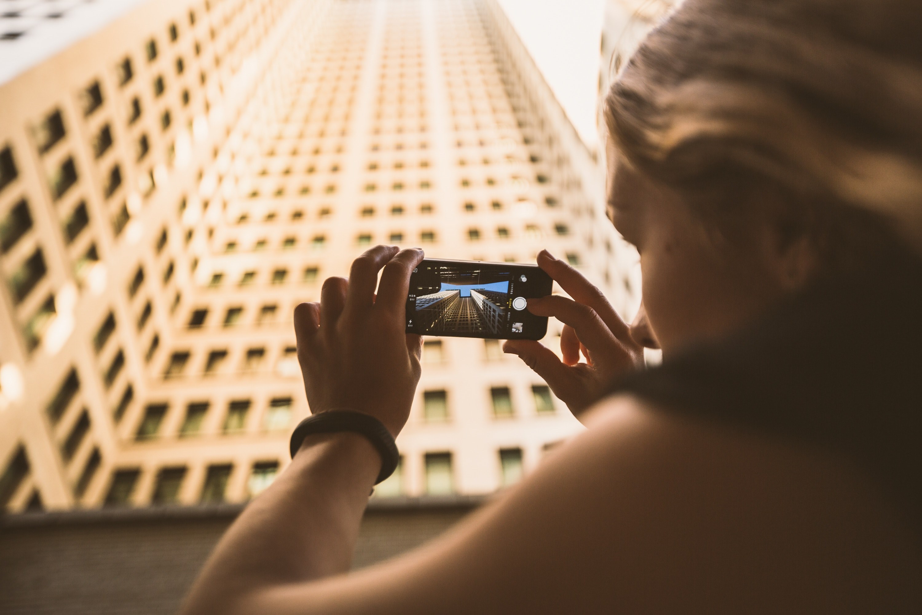 a photo of a woman taking a photo on an iphone cellphone of a building, tourist photography 4k, HD Wallpaper
