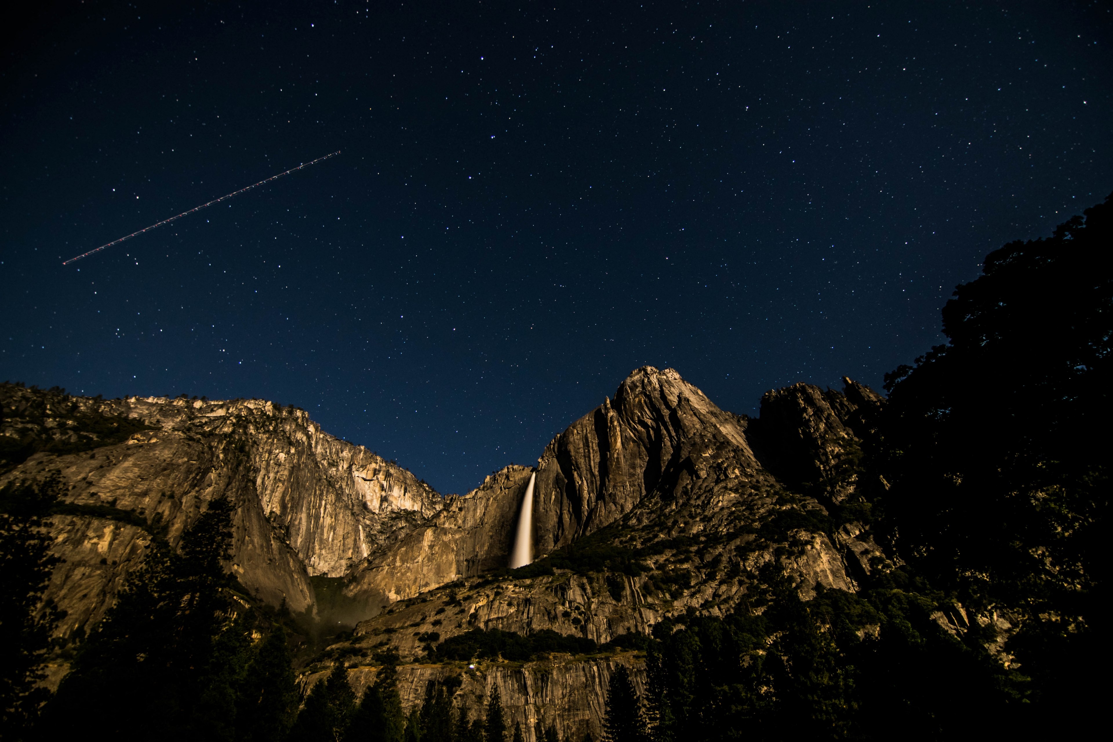 a starry sky with a shooting star over a granite face with a waterfall in the yosemite valley, moon kingdom 4k, HD Wallpaper
