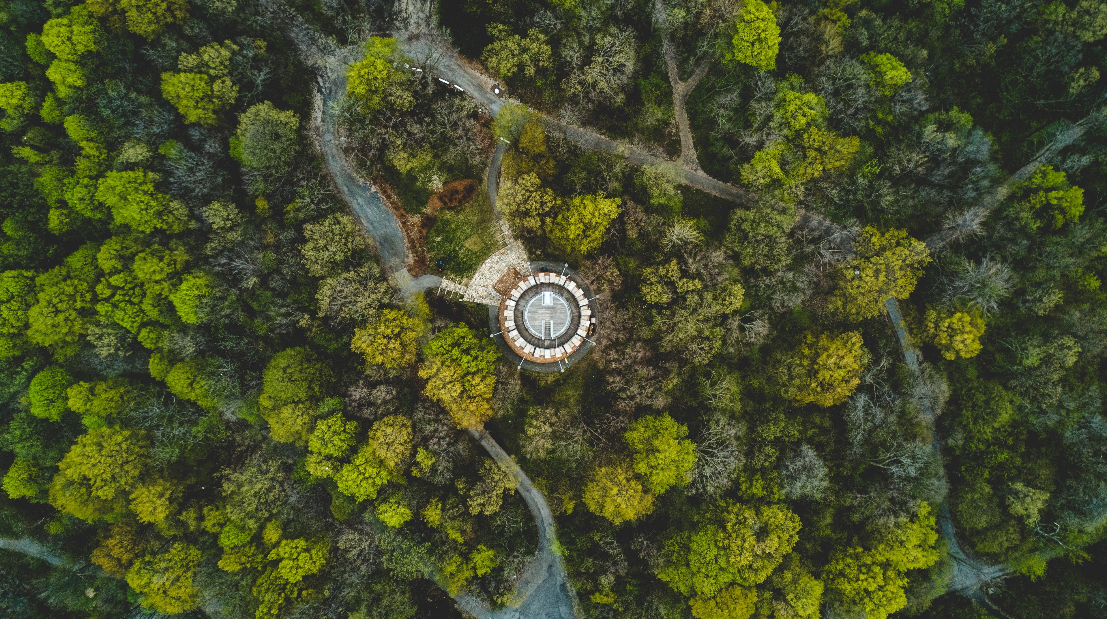 a drone shot of a round building in a wooded area with narrow footpaths, lonely island 4k, HD Wallpaper